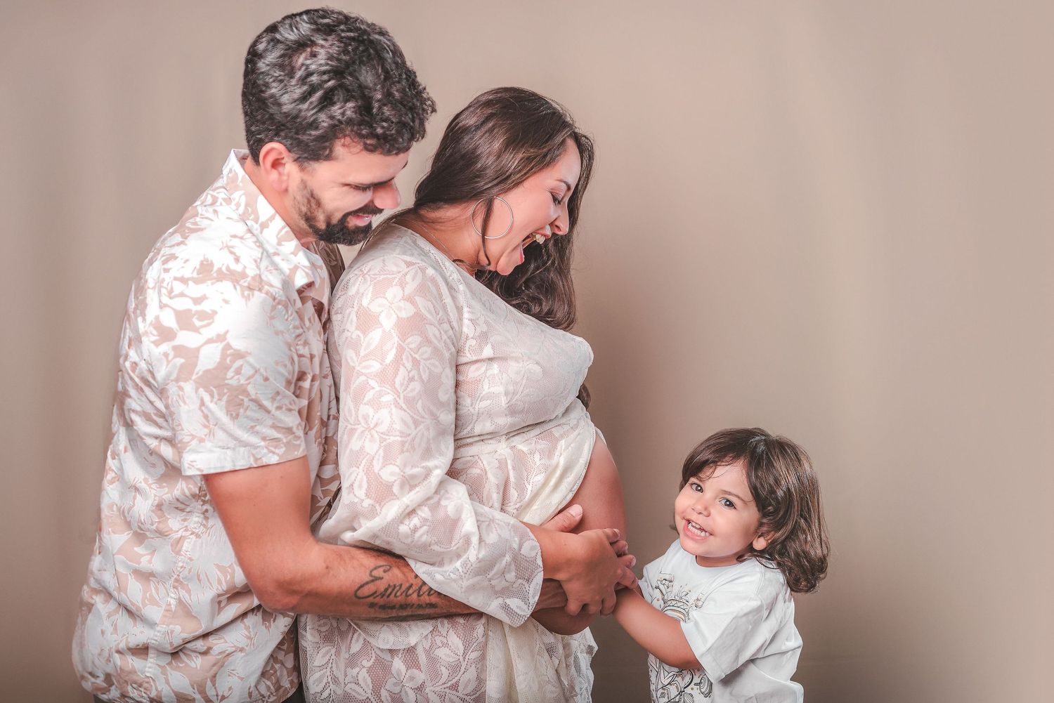 A series of tender maternity photos showing intimate moments in a white lace dress against a neutral backdrop.