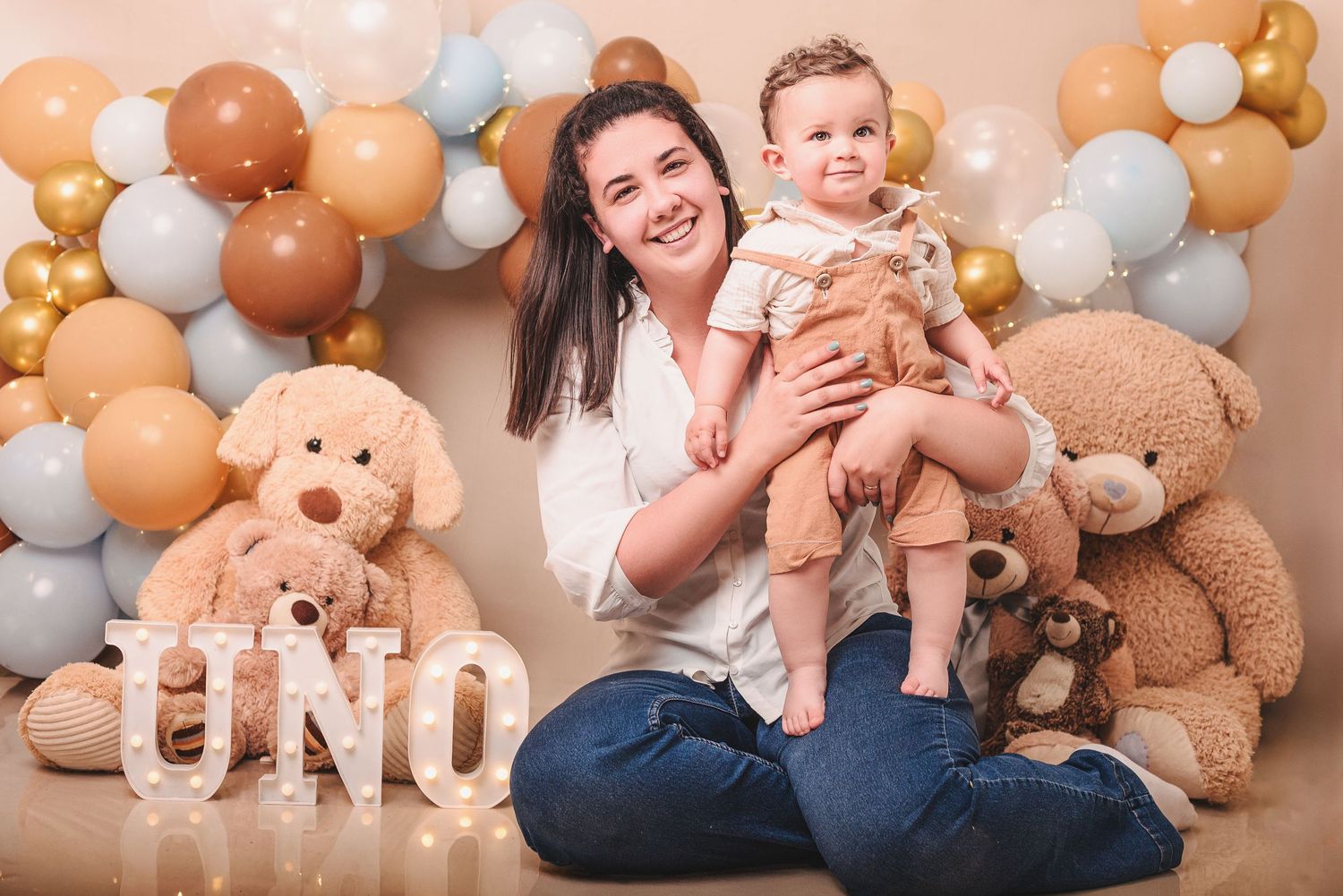 A collection of family photo frames showing tender moments with brown teddy bears and peach-colored balloon decorations.