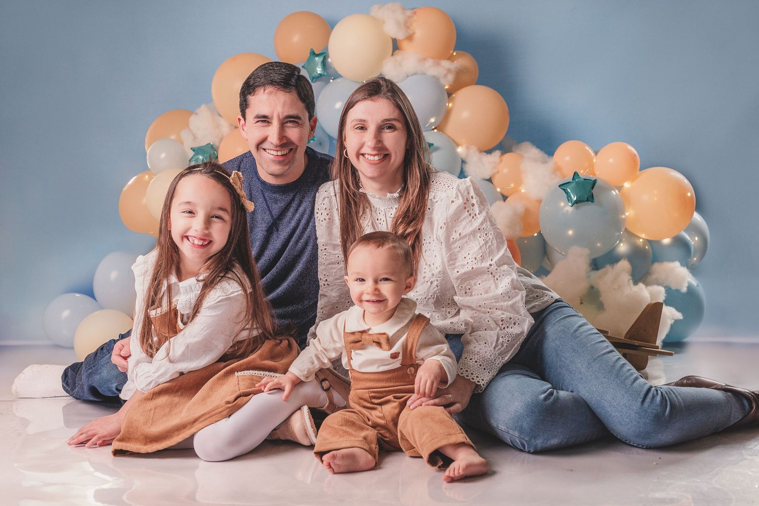 A collection of five family photos arranged side by side showing warm moments against a gray backdrop.