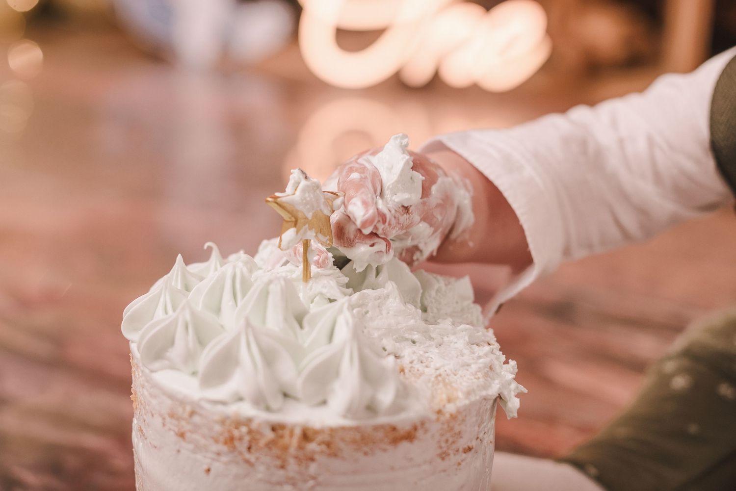 A close-up view of a slice of creamy peanut butter pie topped with whipped cream and crushed peanuts.