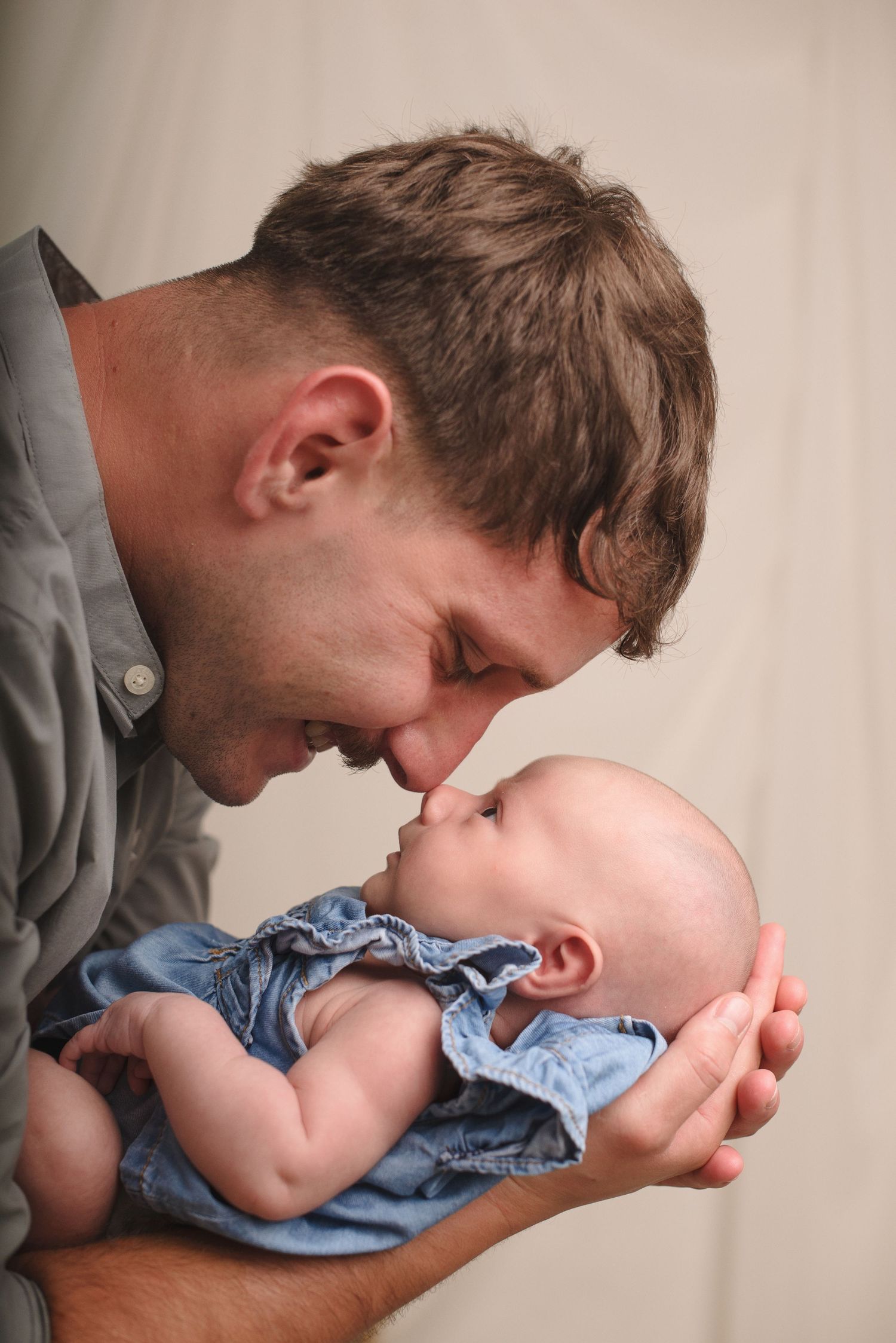 A series of tender moments showing a parent gently kissing a baby's feet while the infant wears blue clothing.