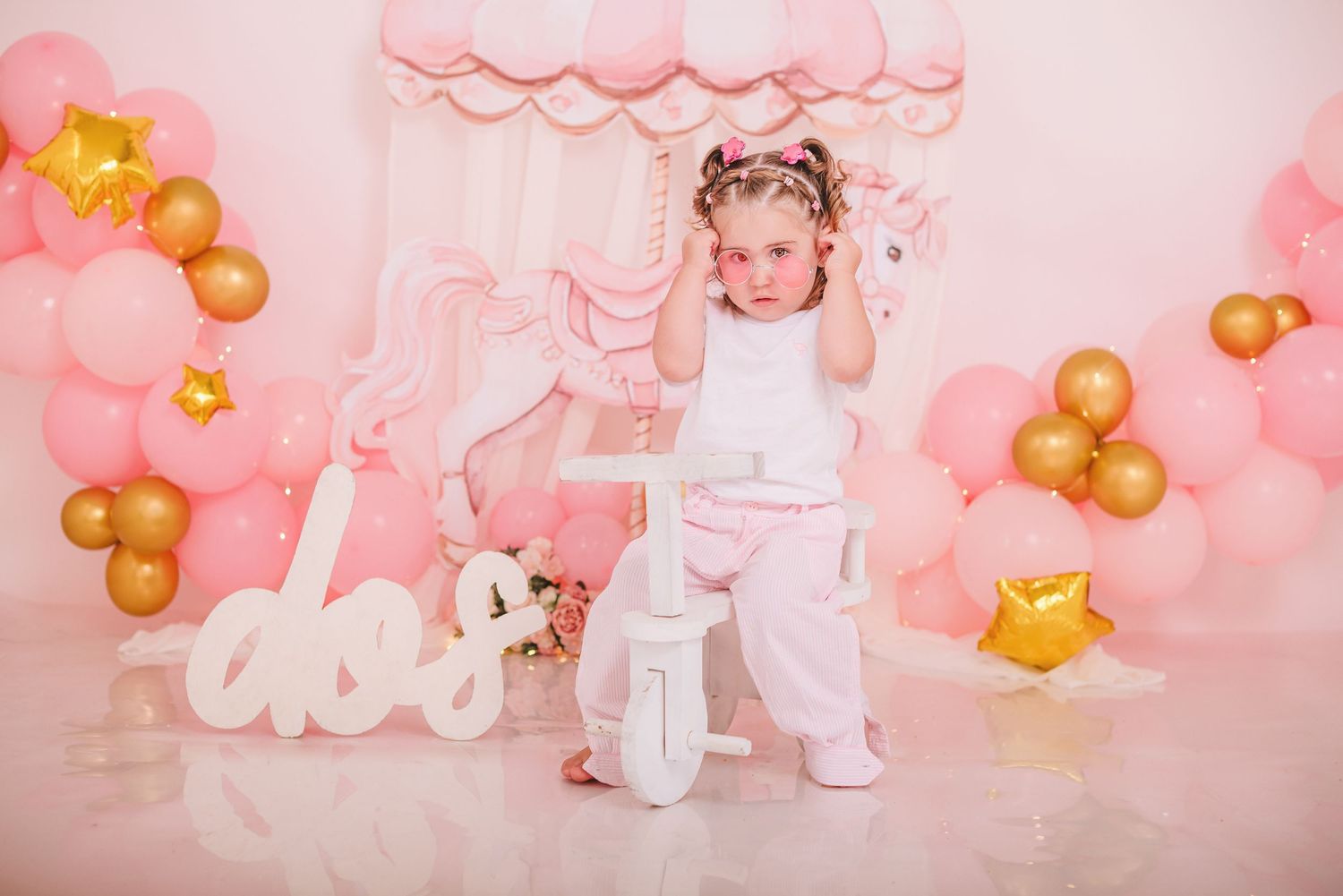Adorable pink and gold balloon party setup with cloud decorations and teddy bear accents.