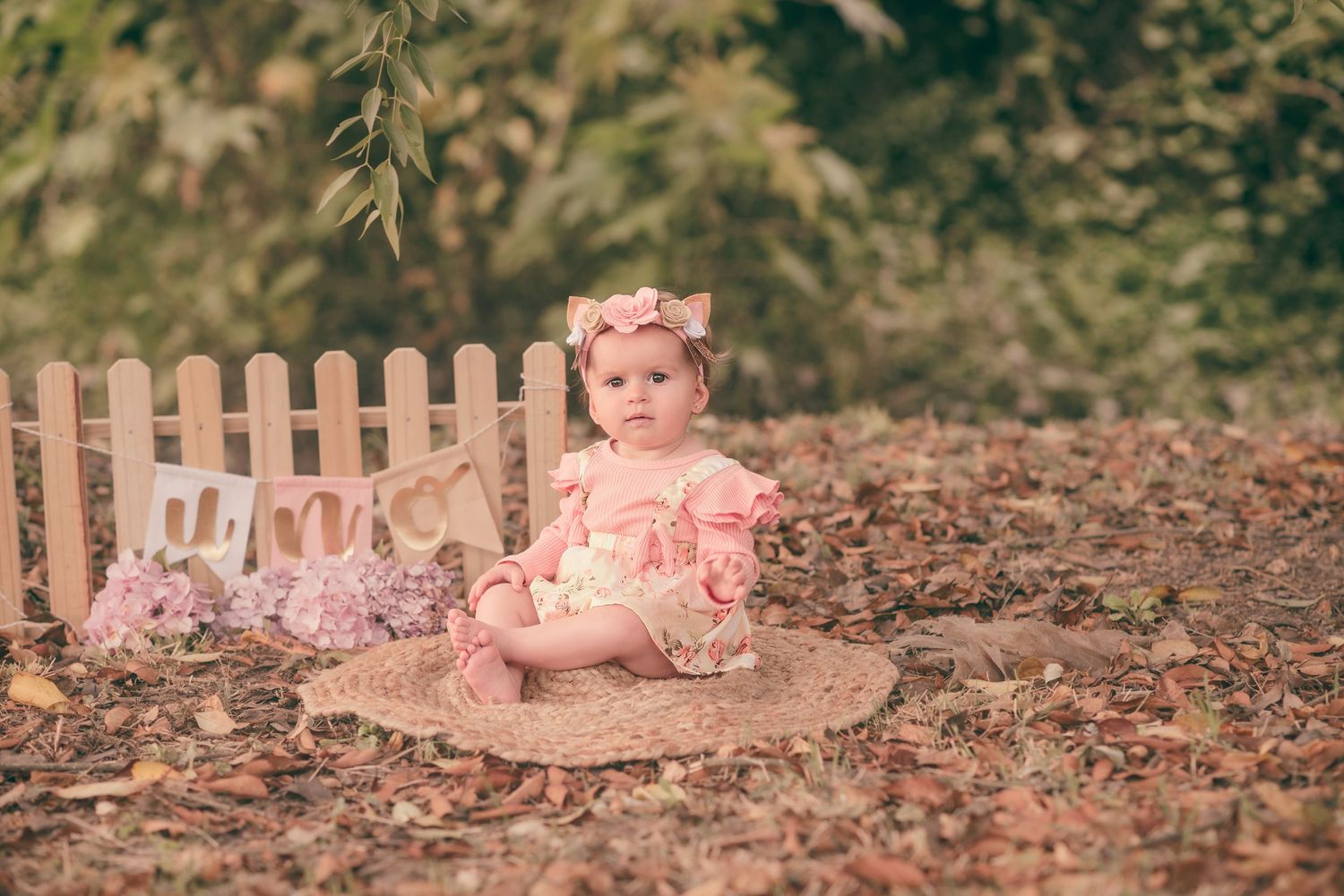 A series of photos showing a baby lying on autumn leaves in a garden setting.