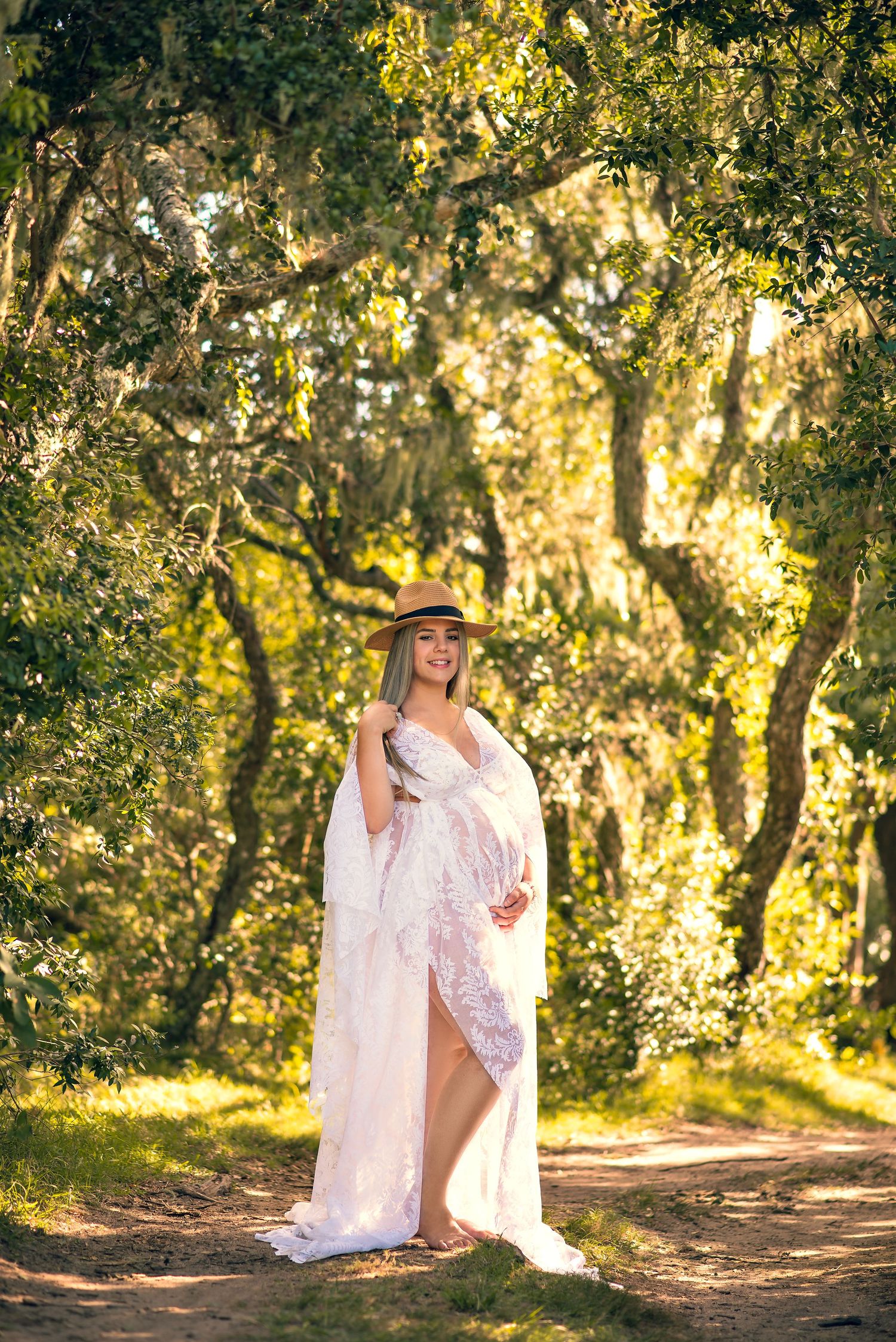 A series of romantic portraits in a sunlit forest setting with flowing white dress and brown hat creating dreamy atmosphere.