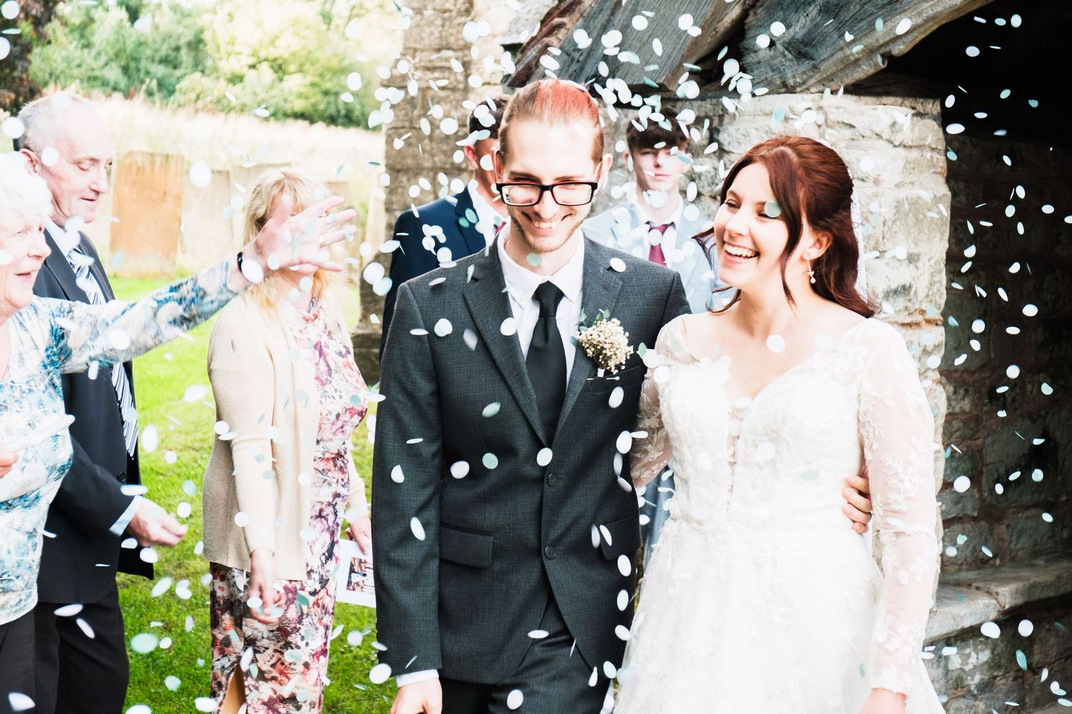 A celebratory moment with confetti falling in an outdoor garden setting.