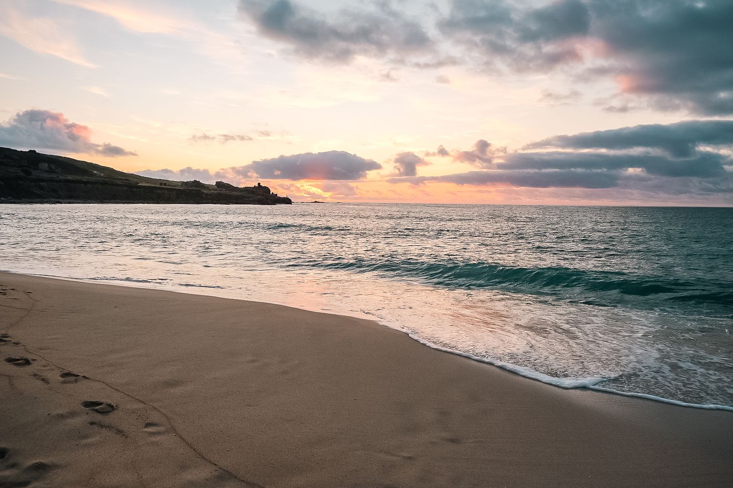 A beach scene from St Ives beach with a sunset overlooking the horizon shot in St ives by 21 Photography