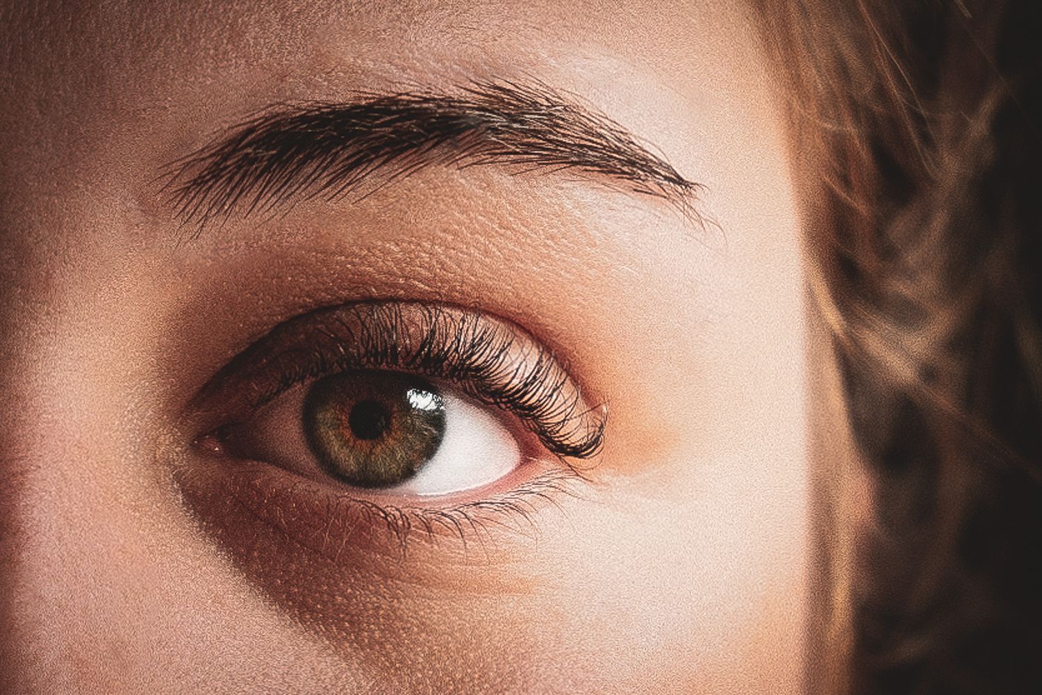 Close up detail of eye makeup with brown eyeshadow and mascara.