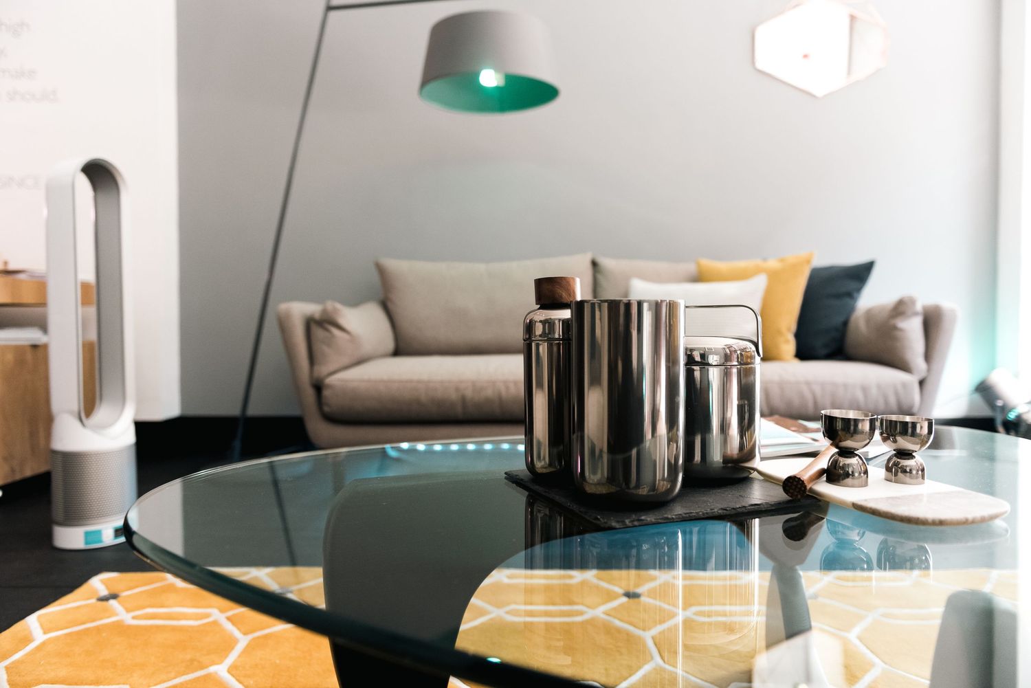 Modern living room interior with glass coffee table, floor lamp, and stylish gray sofa shot in Leeds by 21 Photography