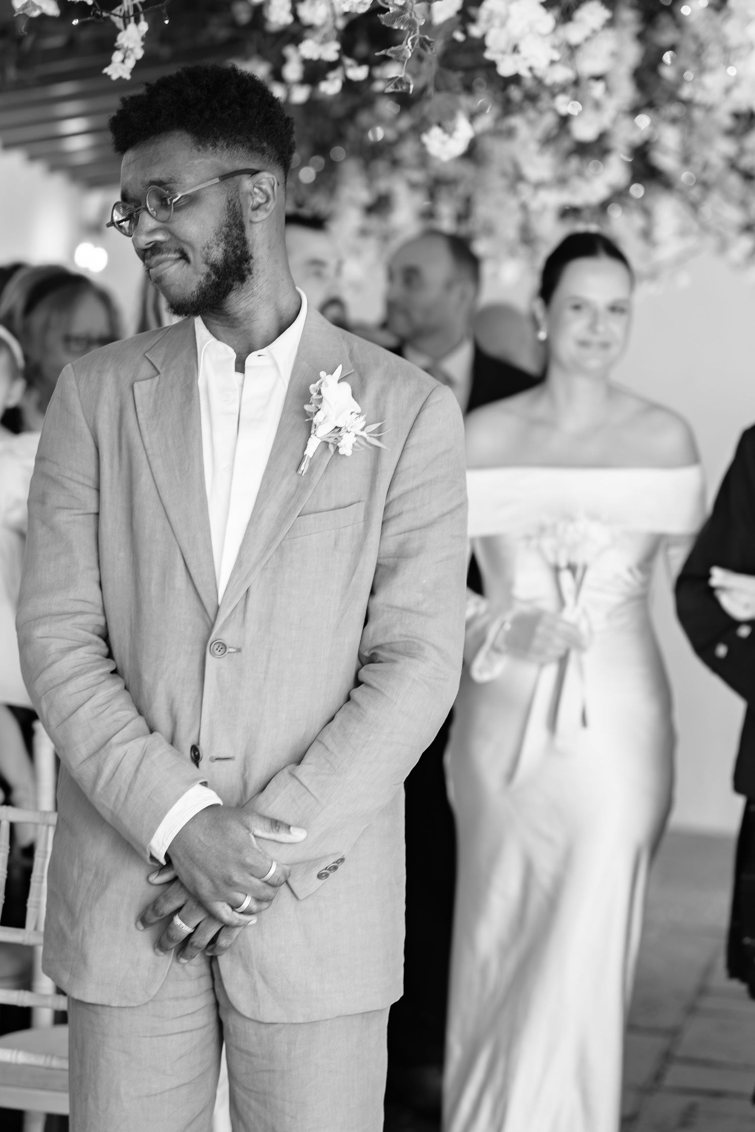Groom smiling as his bride walks up the aisle at Dunston Hall, Derbyshire