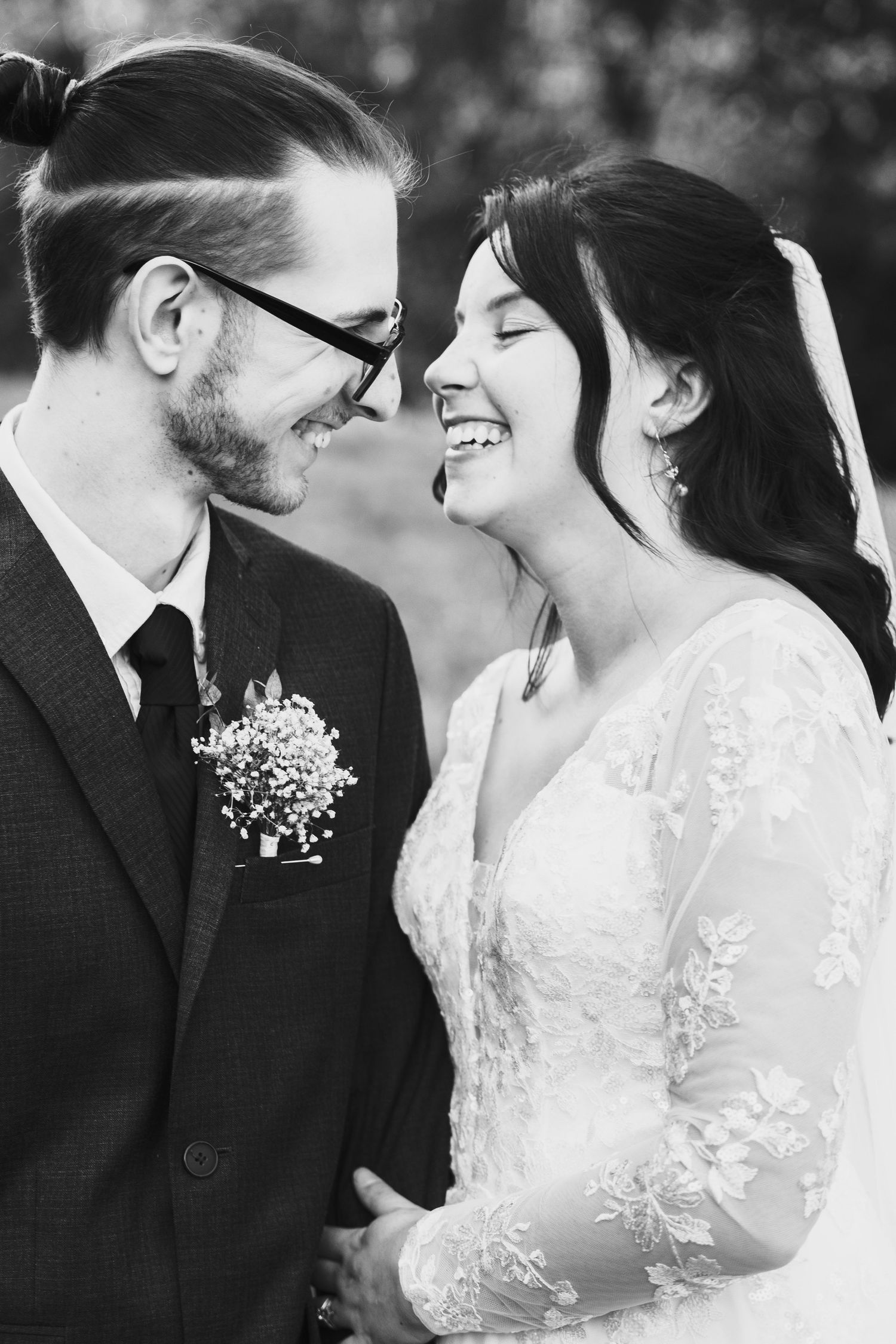 Black and white romantic wedding show tender moments between newlyweds in an intimate setting taken by chesterfield wedding photographer
