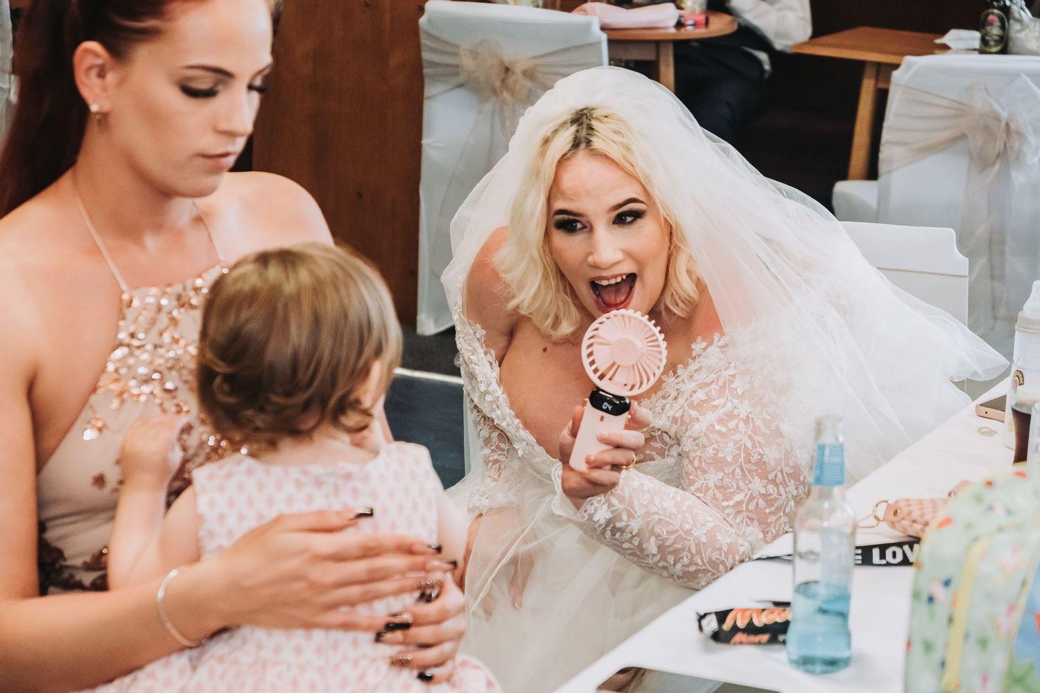Candid wedding reception shots showing guests toasting and socializing.