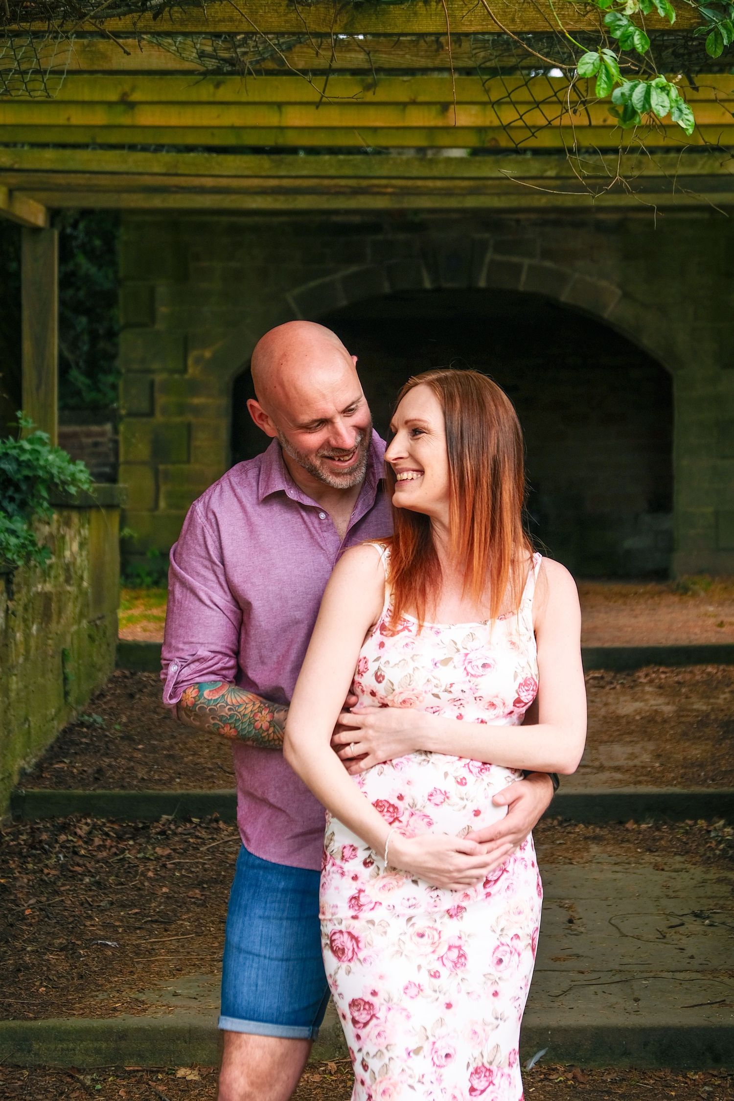 Intimate moments captured between a couple in coordinating pink attire.