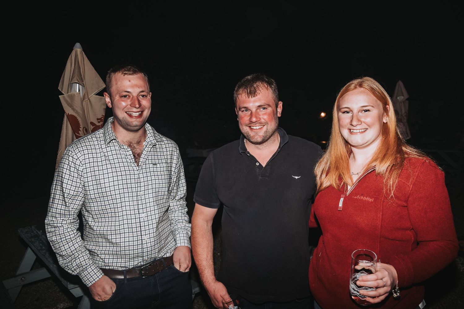 Group of friends socializing together against a dark background.