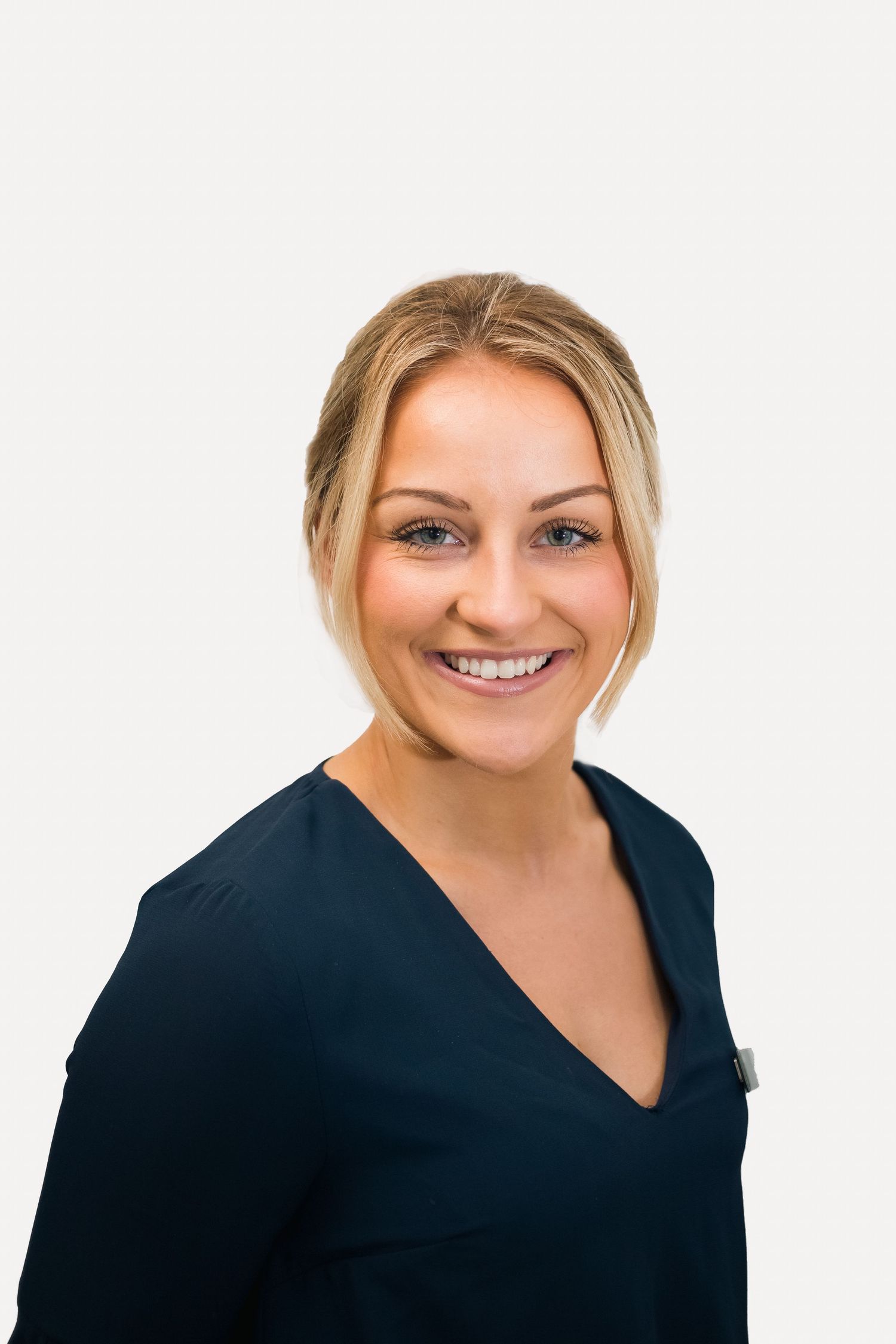Professional headshot against white background wearing a navy V-neck top shot in Leeds by 21 Photography