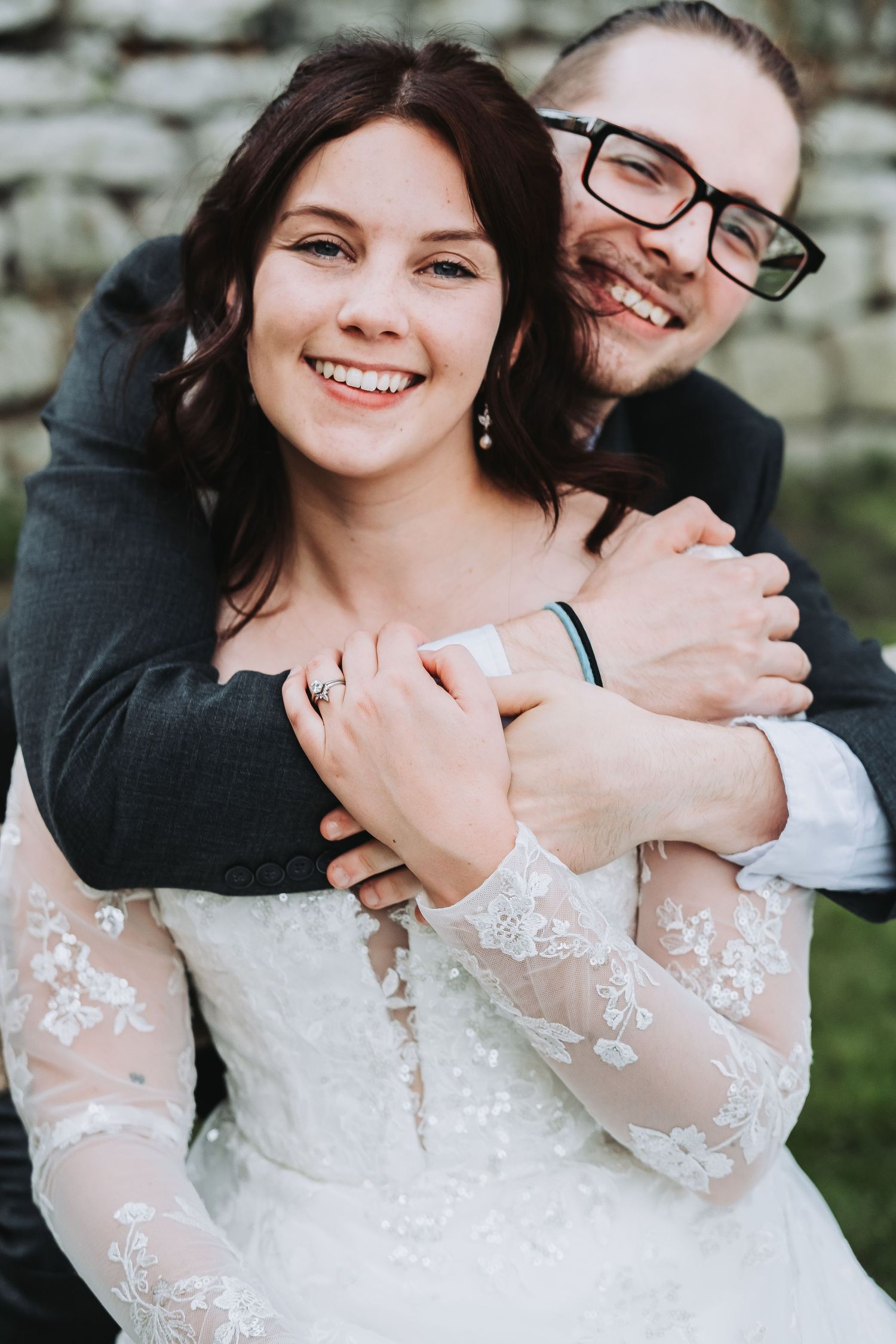 A romantic embrace captured in close-up during outdoor wedding portraits.