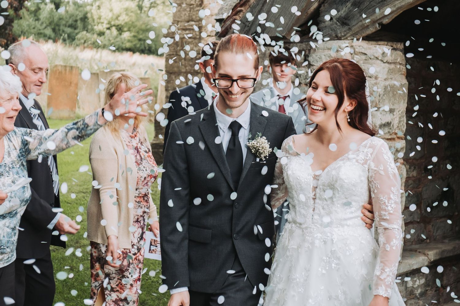 Bride and groom smiling during the confetti walk at a Chesterfield church wedding