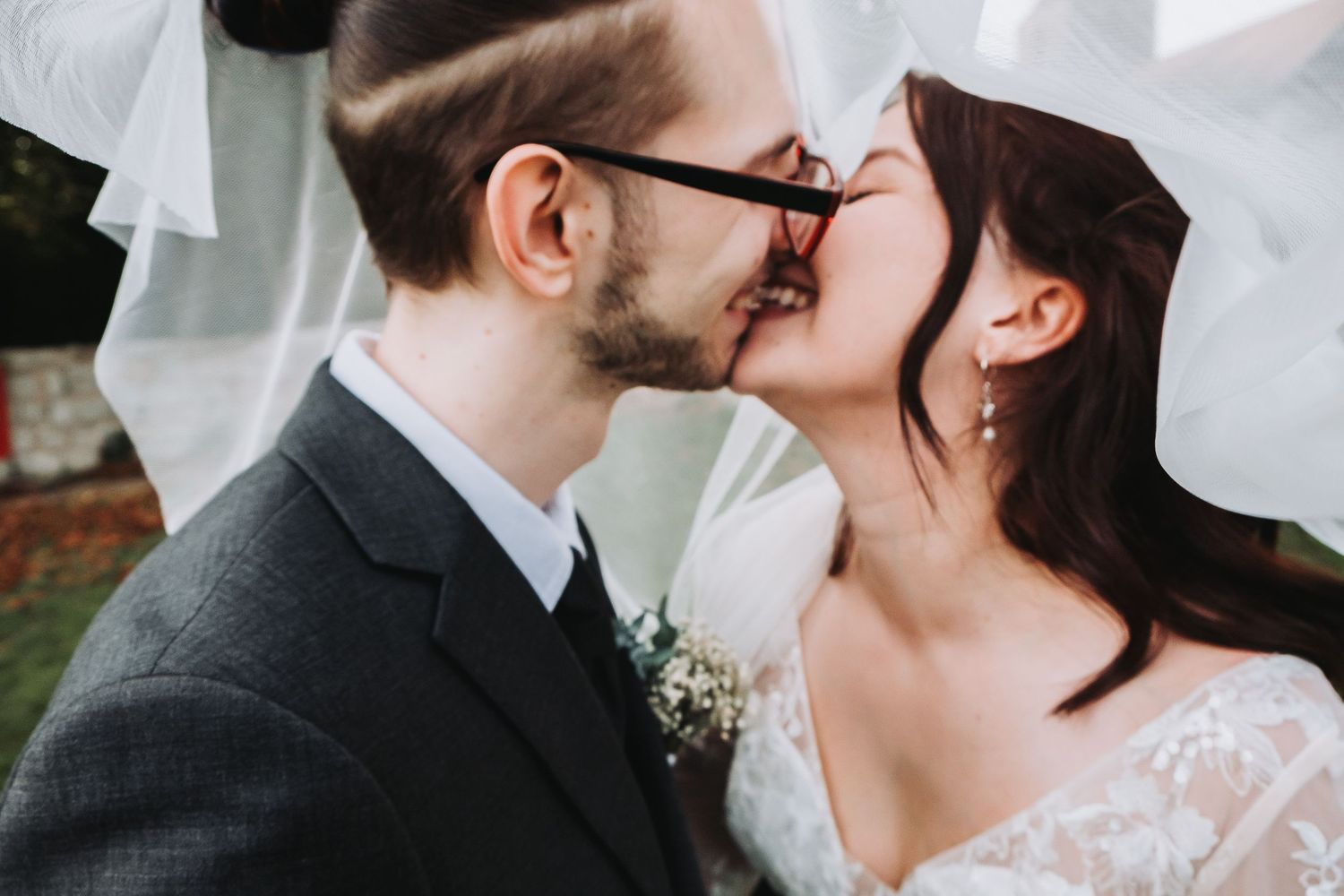 A romantic wedding portrait showing a couple in elegant attire sharing a tender moment.