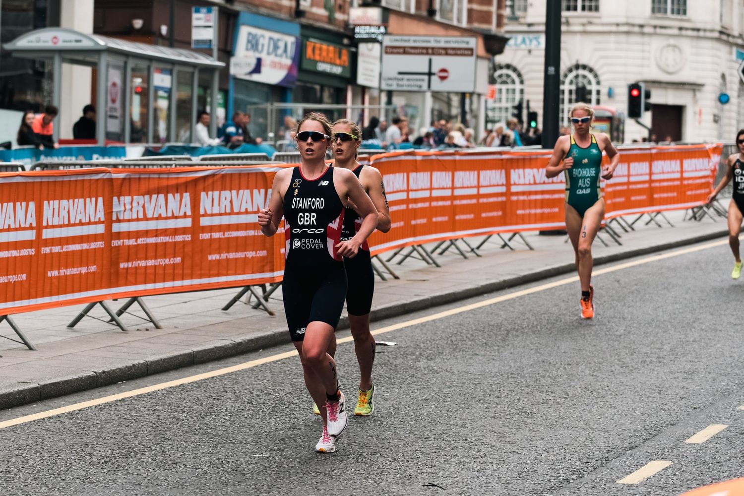 Triathlete running on urban course with crowd barriers and spectators shot in Leeds by 21 Photography