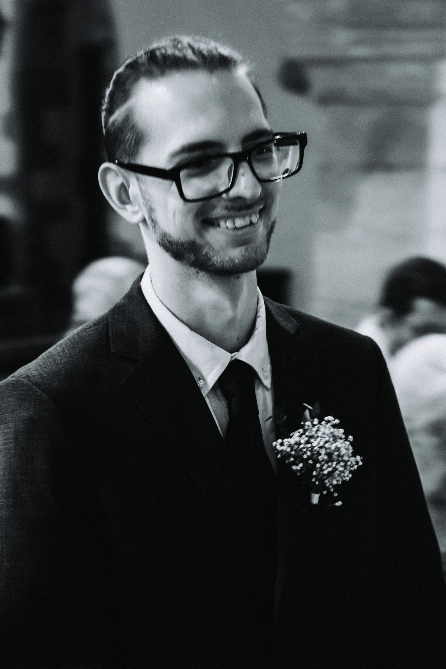 Groom smiling with boutonniere during vow renewal photography session in Derbyshire.