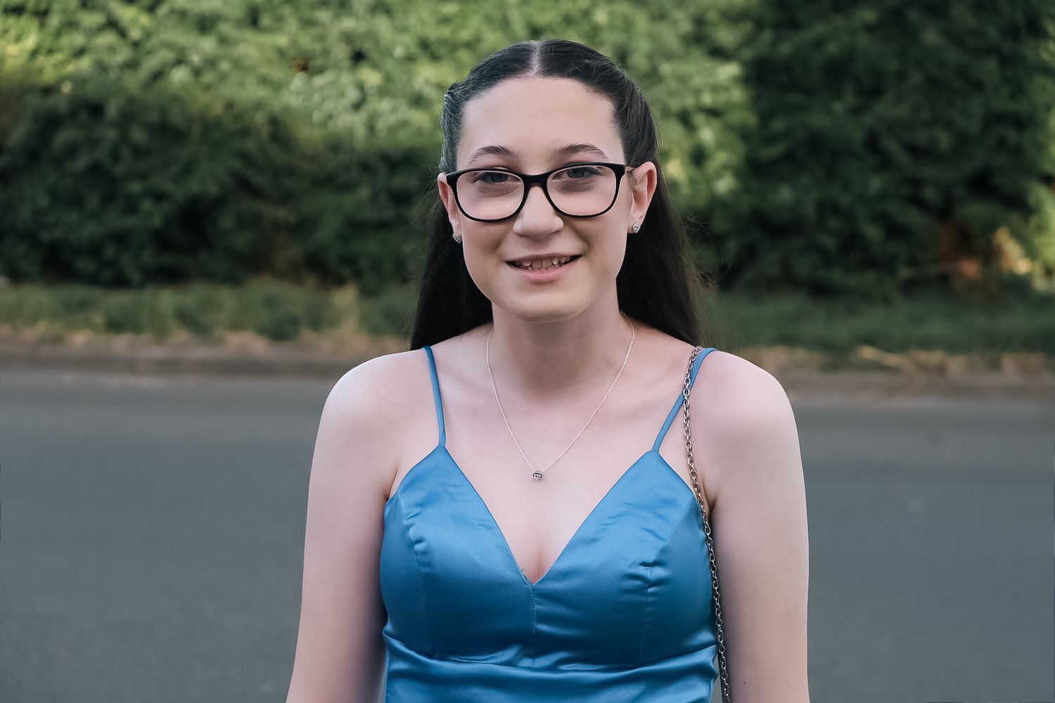 Portrait of someone in blue dress and glasses against outdoor background shot in Chesterfield by 21 Photography