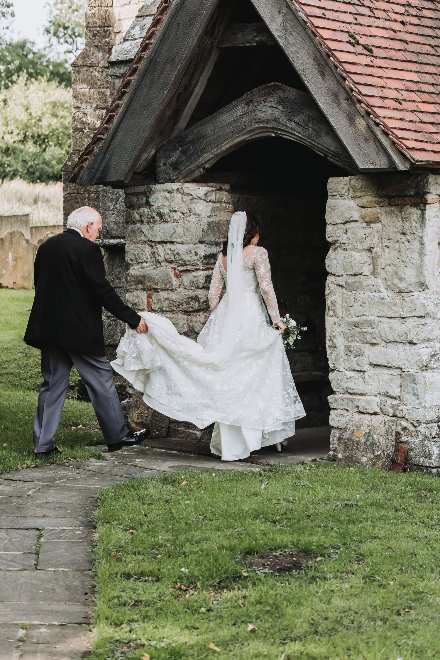 A sequence of photos showing a couple taking shelter from rain under a stone archway entrance at a rustic building.
