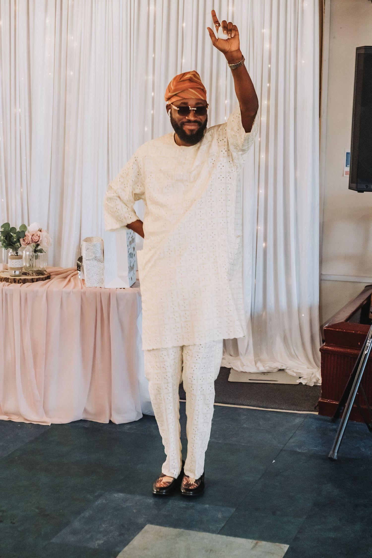 A sequence of five photos showing someone in a flowing white traditional outfit dancing and expressing joy at a celebration.