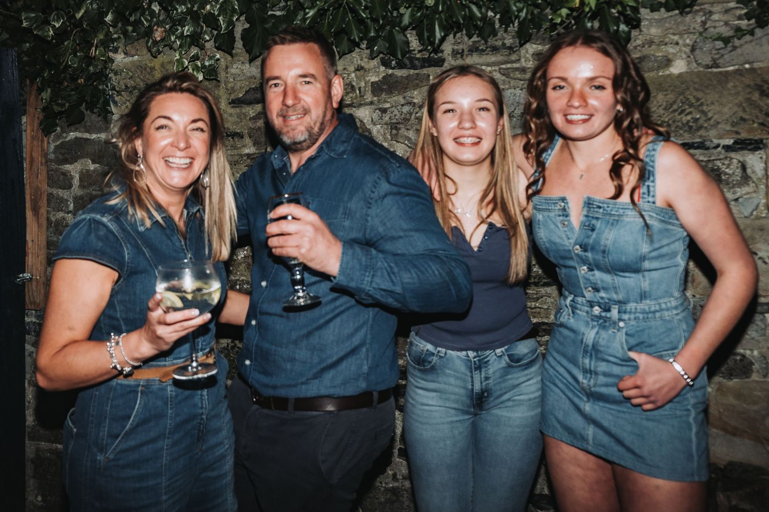People in denim and casual clothing gather together for a social event.