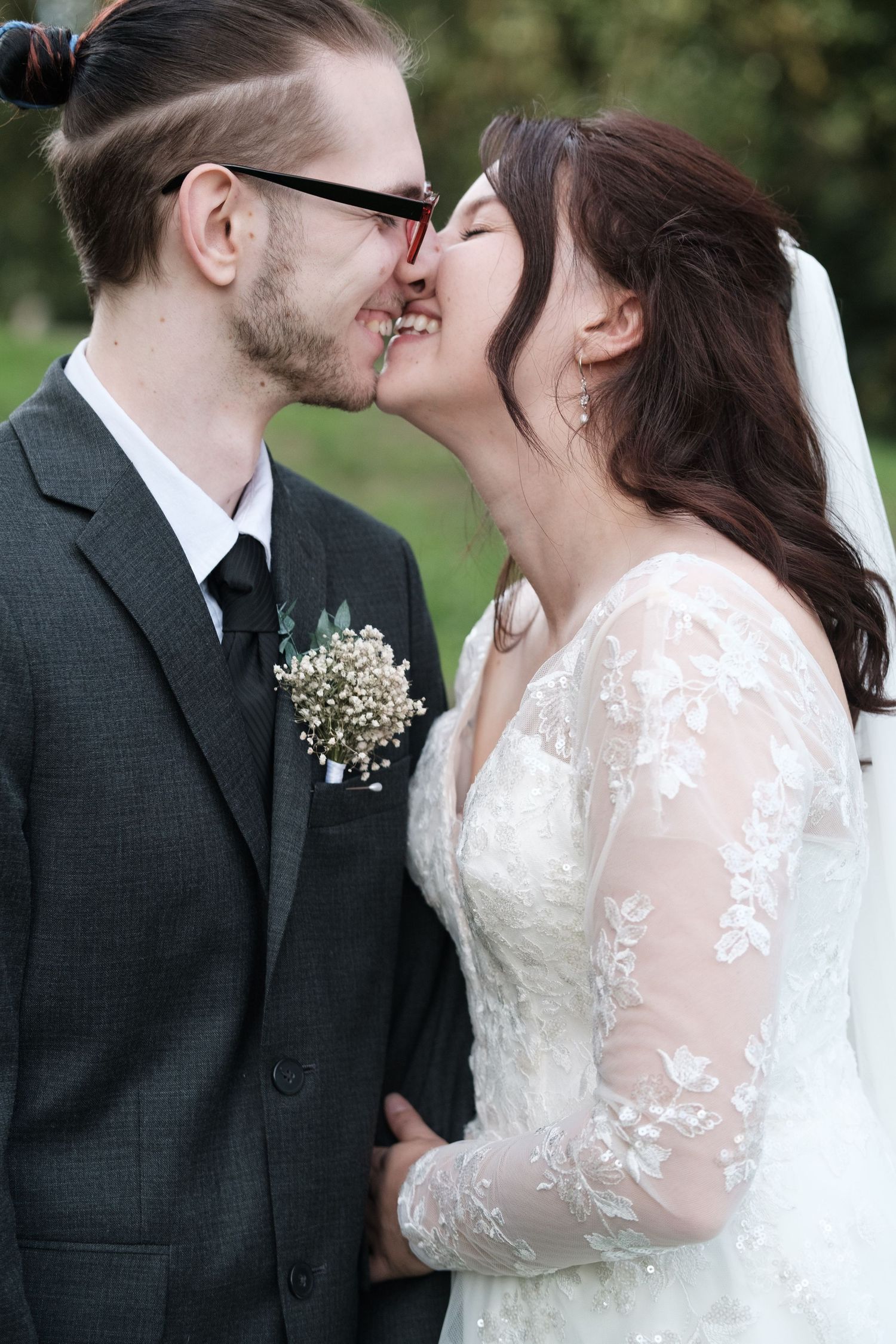 A romantic wedding couple shares tender moments in a series of intimate outdoor portraits.