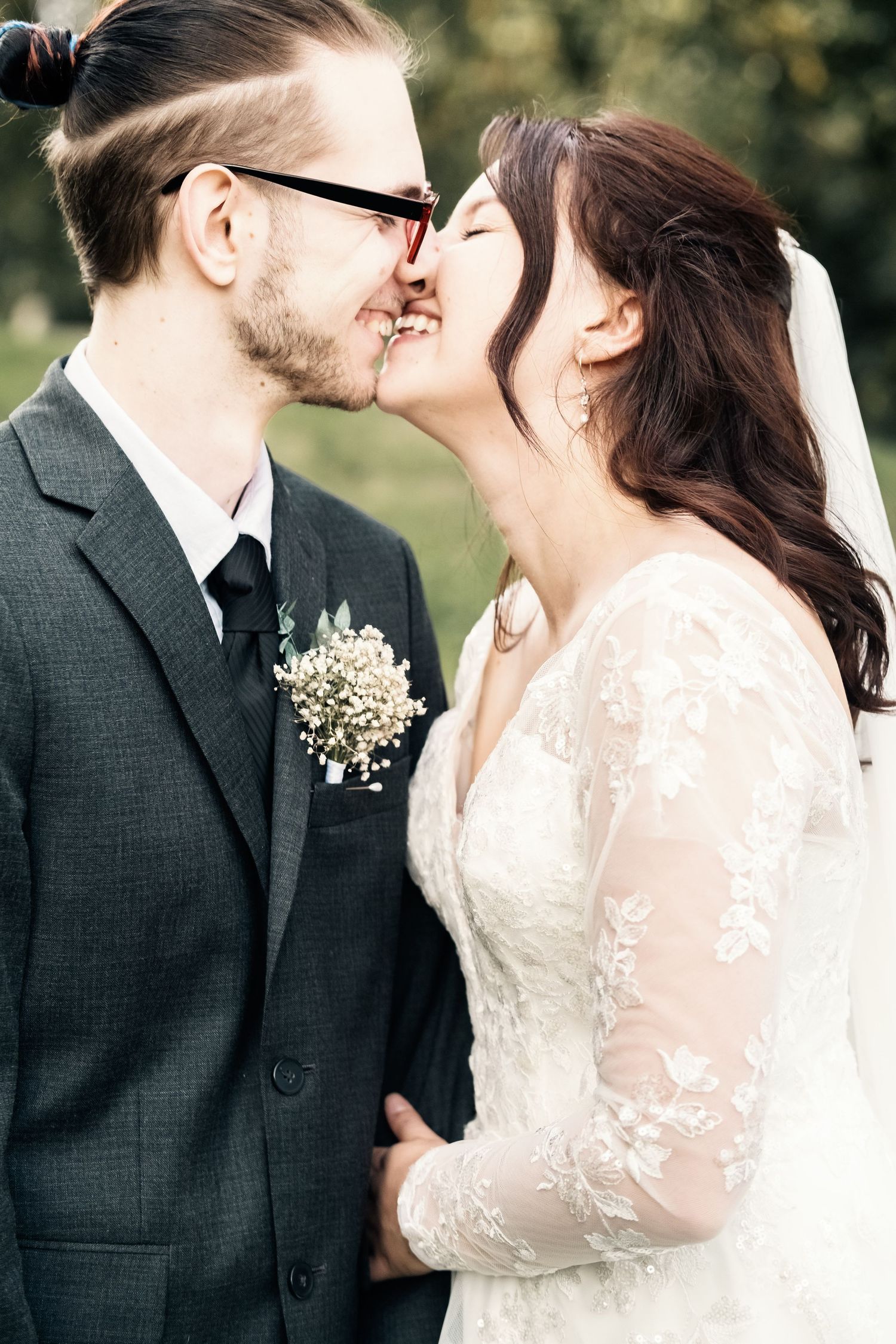 A romantic wedding photo series showing a couple in formal attire sharing intimate moments outdoors.