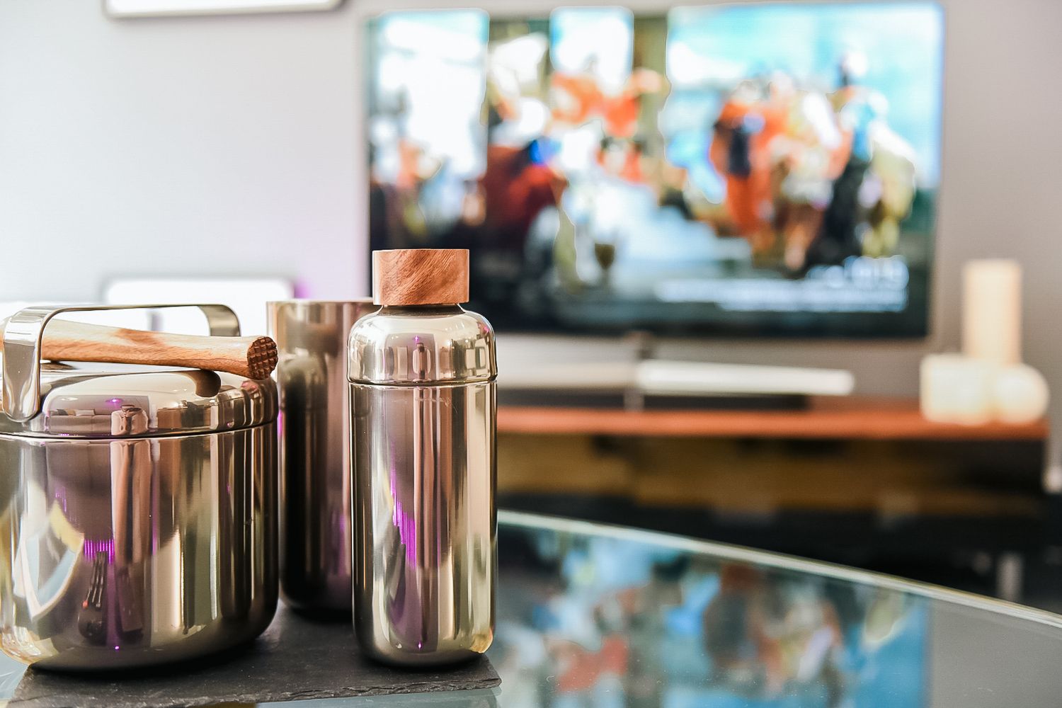 Modern kitchen countertop with stainless steel canisters and TV playing in background shot in Leeds by 21 Photography
