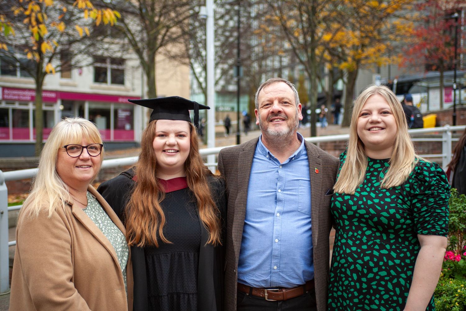 Family group in casual attire gathered outdoors during autumn graduation celebration shot in Sheffield by 21 Photography