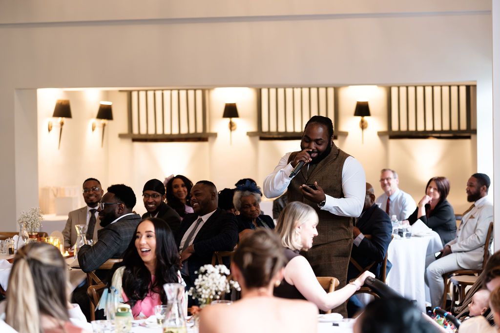 Best man giving a speech in the barn conversion dining room at Dunston Hall