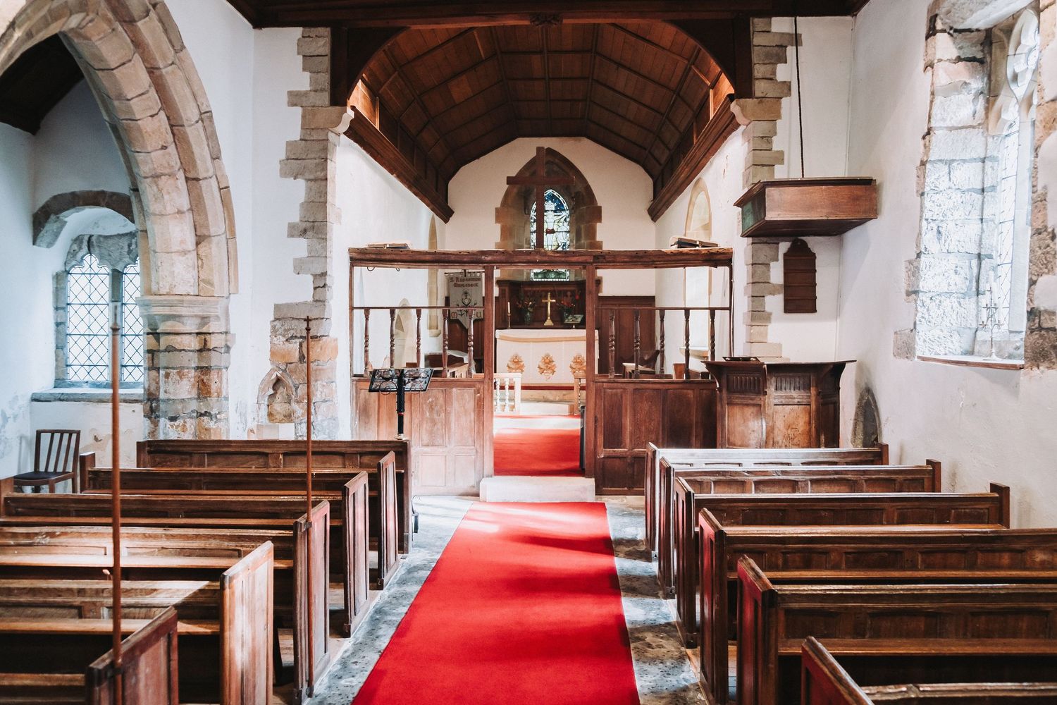 Historic interior of St Radegund’s Church with wooden pews and arched ceilings for vow renewal photography.