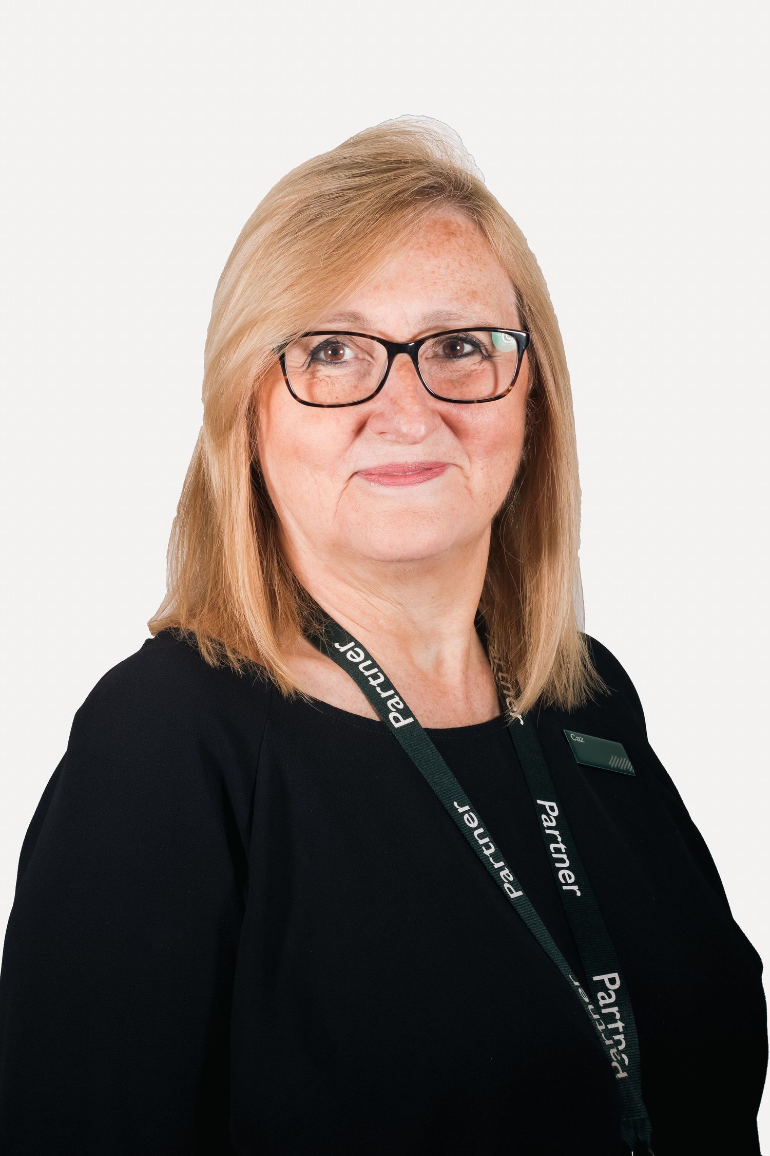 Professional portrait of staff member wearing glasses and black top with lanyard shot in Leeds by 21 Photography