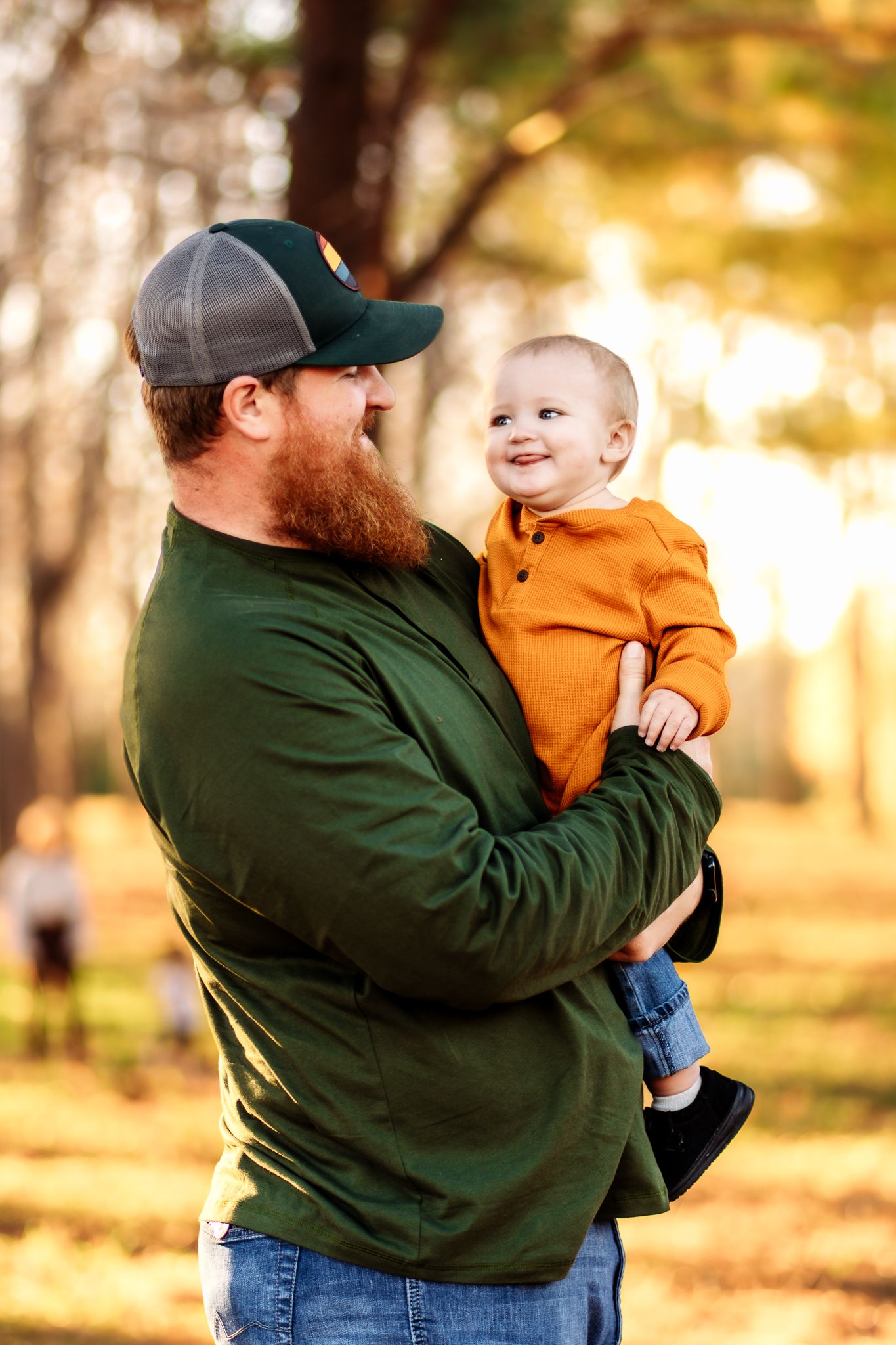 A heartwarming sequence of parent and child playing together in a sunlit autumn park setting.