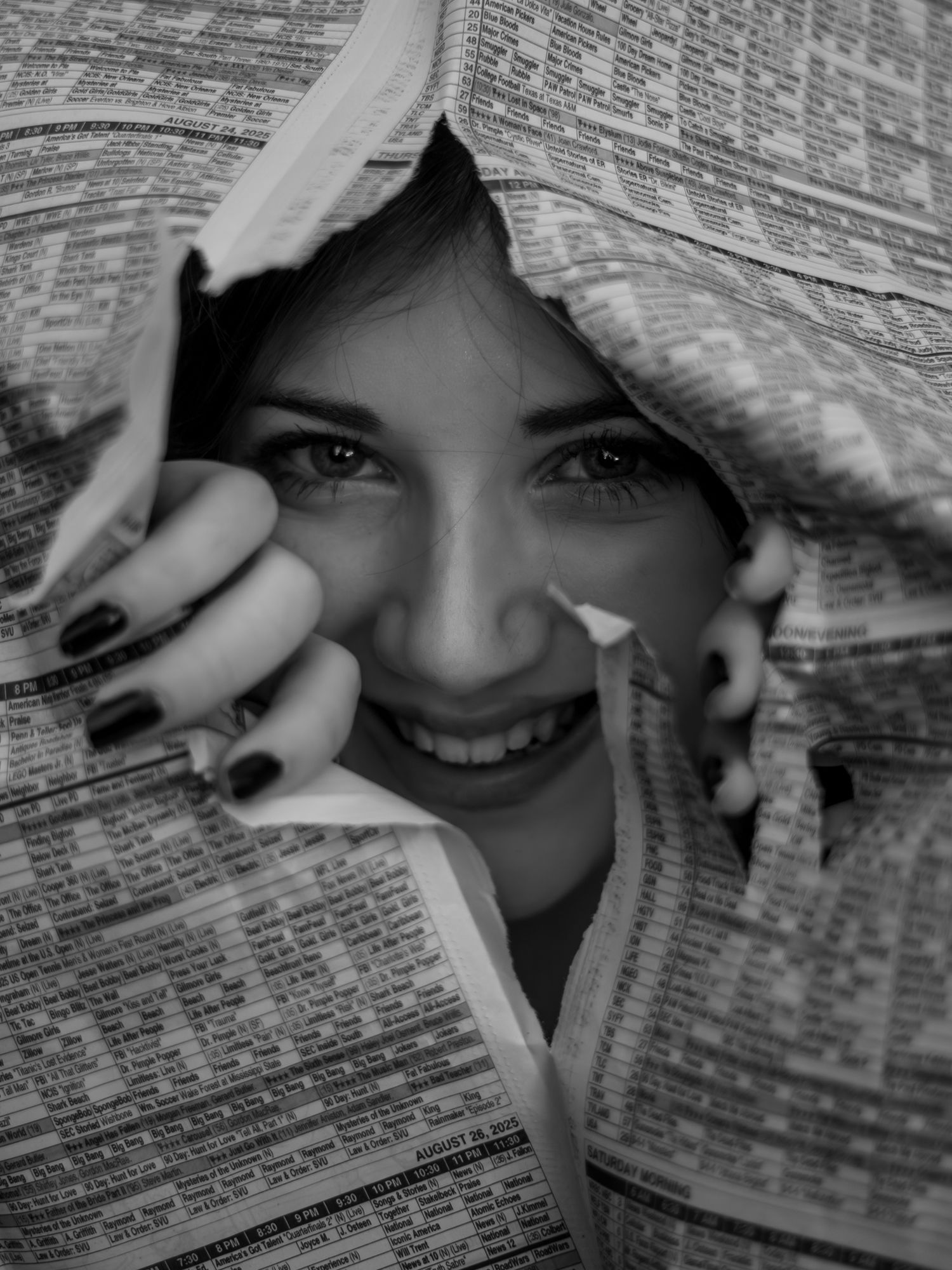 A creative photo series showing someone peeking through torn newspaper pages with dramatic lighting and contrast.