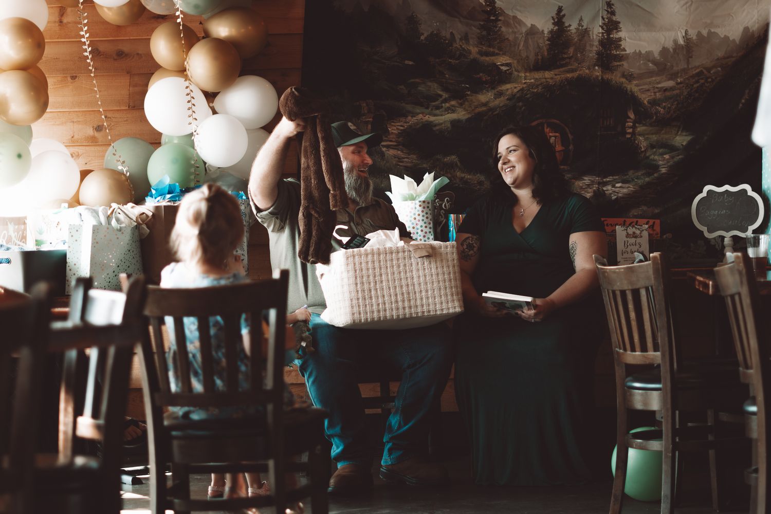 Event space decorated with metallic balloons and ambient lighting.