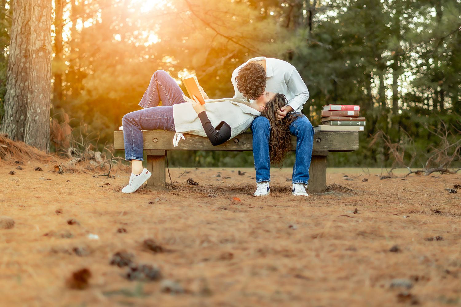 A couple enjoys a playful moment in a sunny outdoor setting.