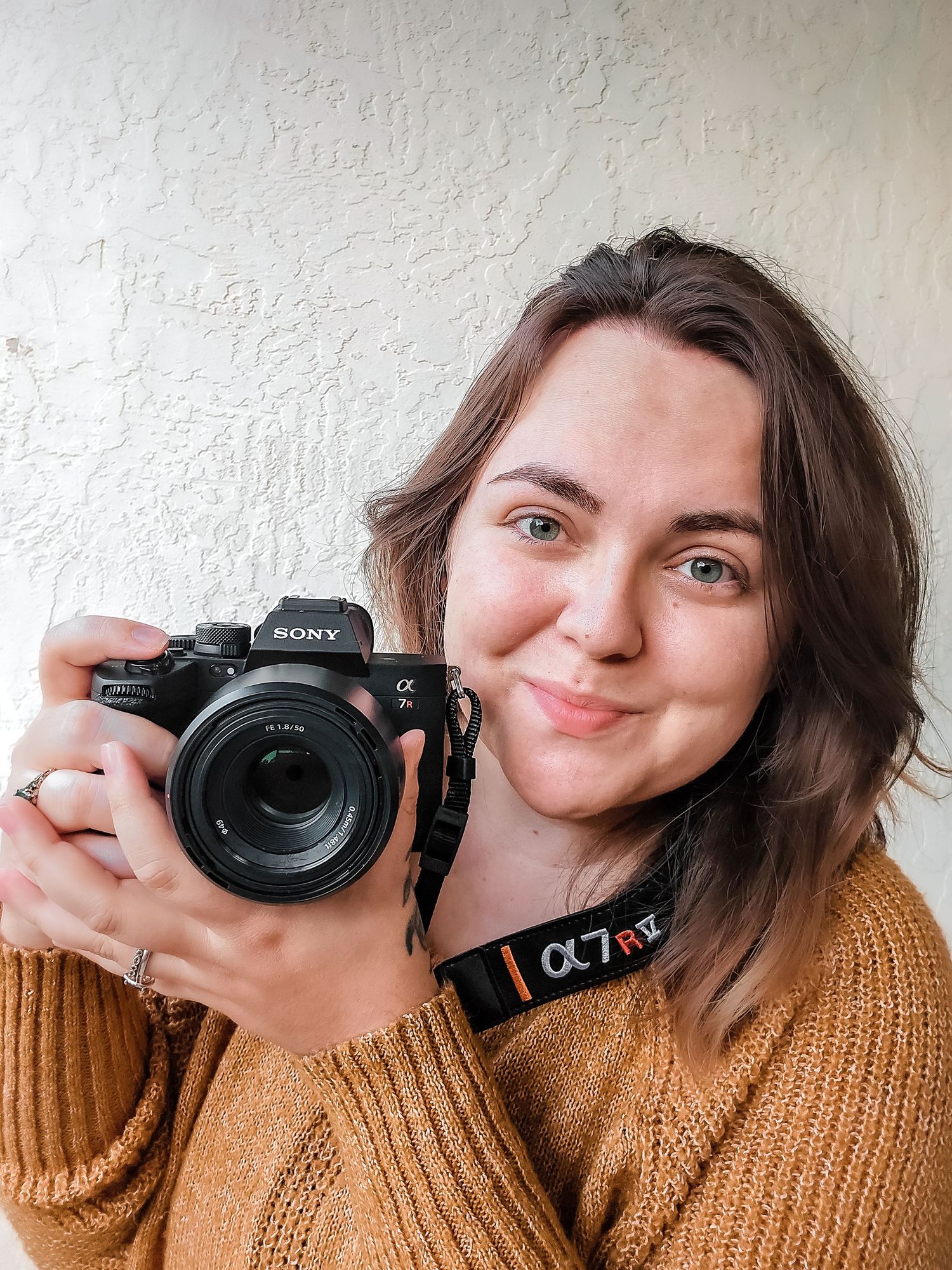 Sony camera photography sequence showing playful poses against a white wall.