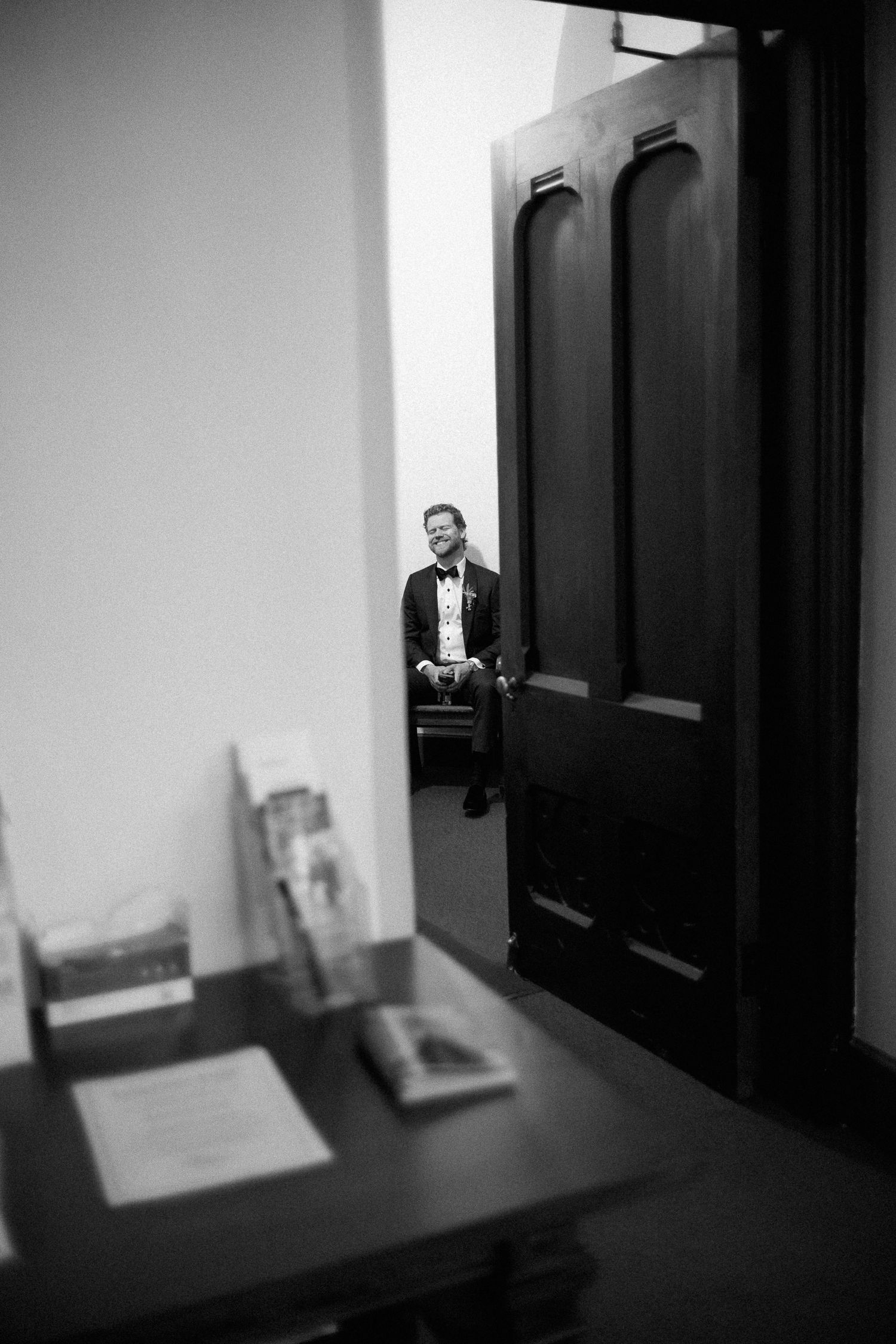 A sequence of black and white photographs showing a dark hallway with dramatic shadows and a door at the end.