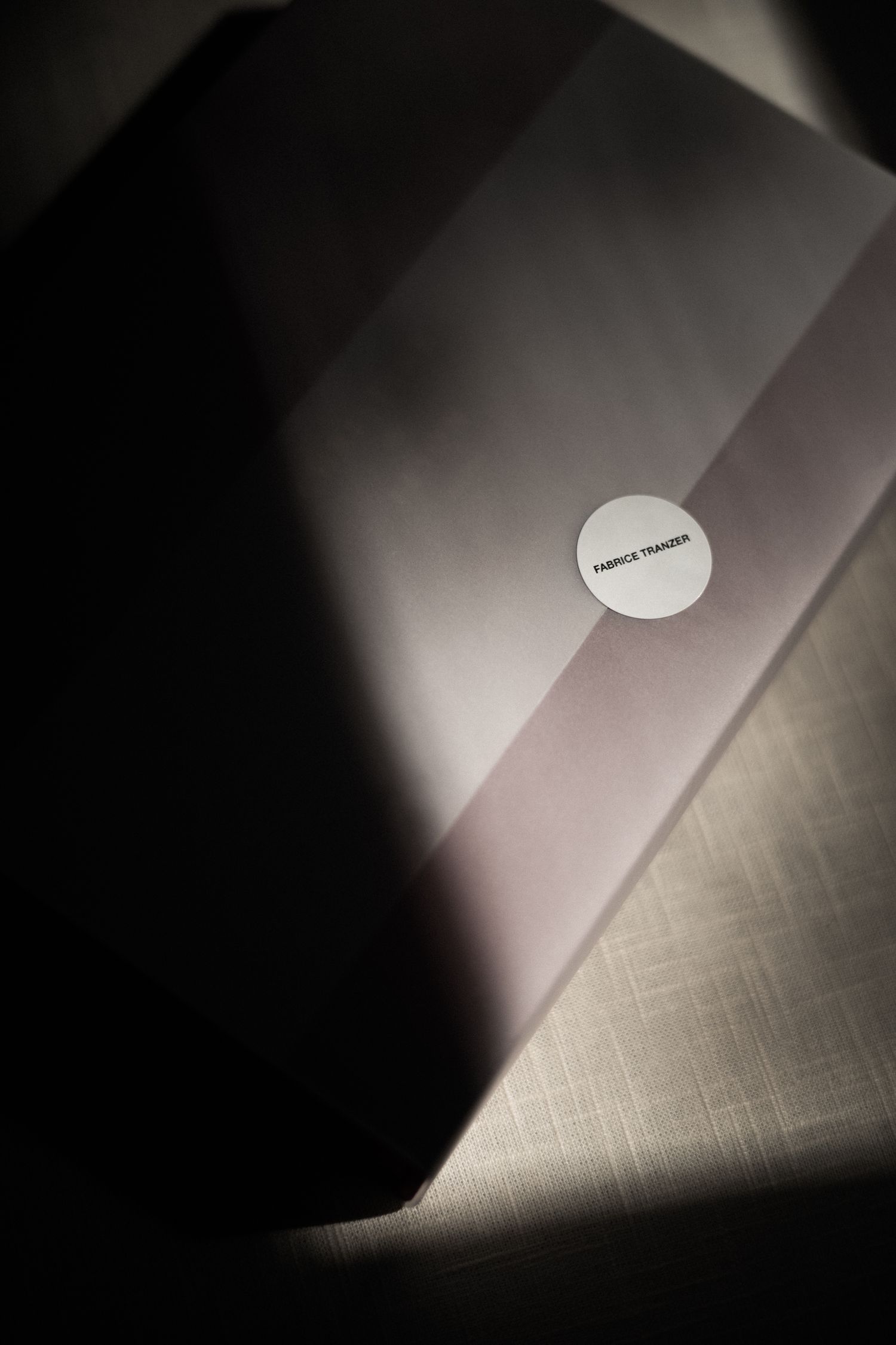 Artistic close-up shot of a white circular sticker on a gradient background.