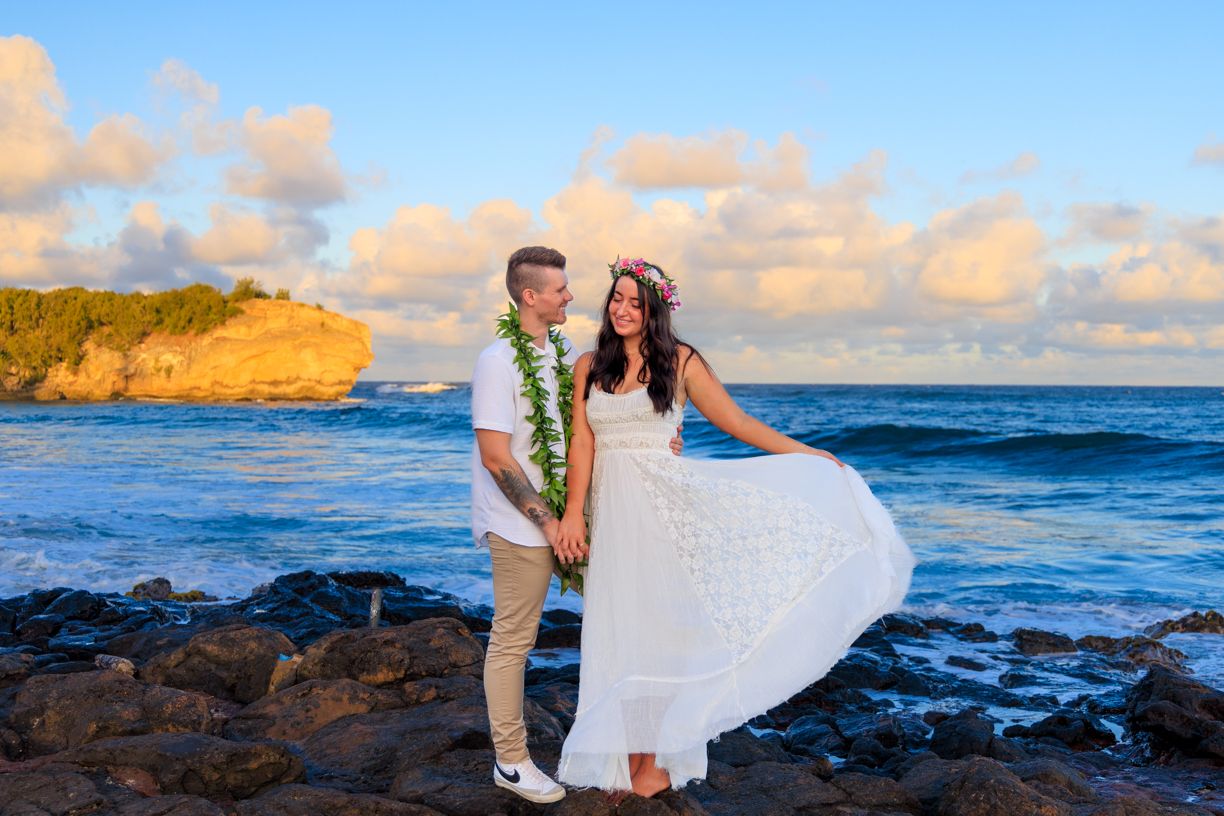 Romantic sunset beach photos with ocean waves and cliffs in the background.