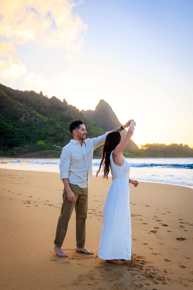A surprise proposal moment captured on a scenic Hawaiian beach during sunset.