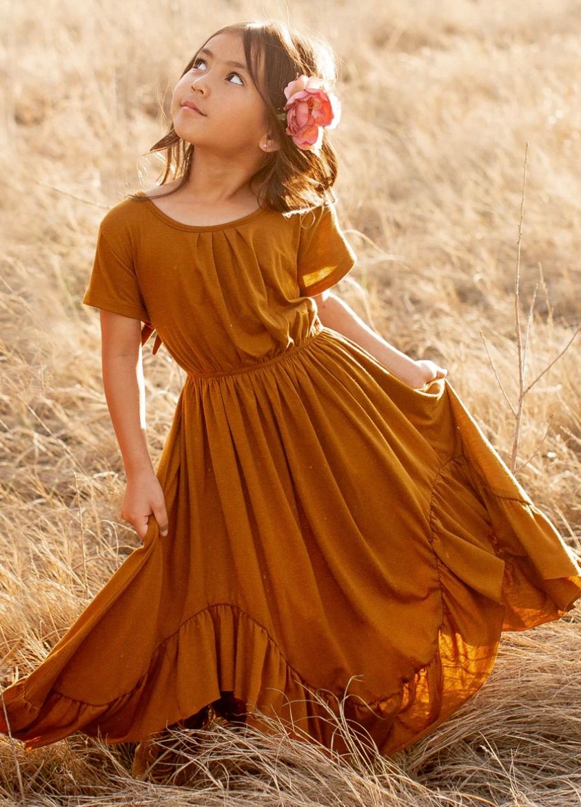 Rustic brown twirl dress captured in motion against golden wheat field background.