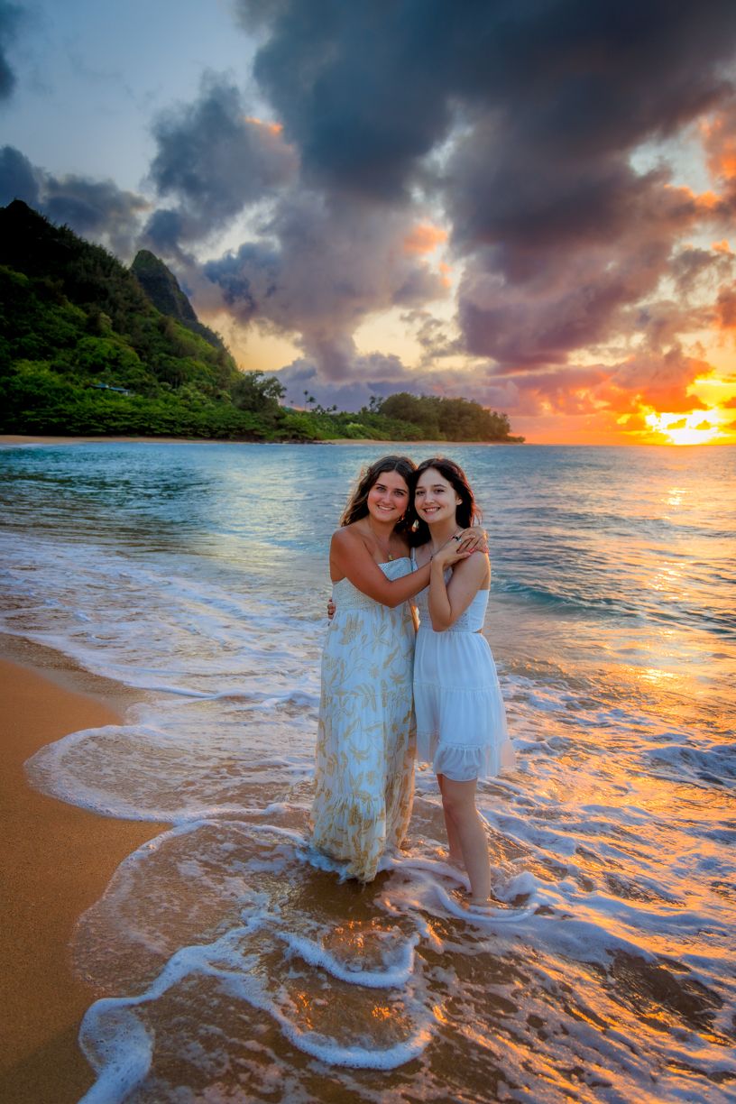 Dreamy beach sunset photoshoot with waves crashing on shore in Hawaii.