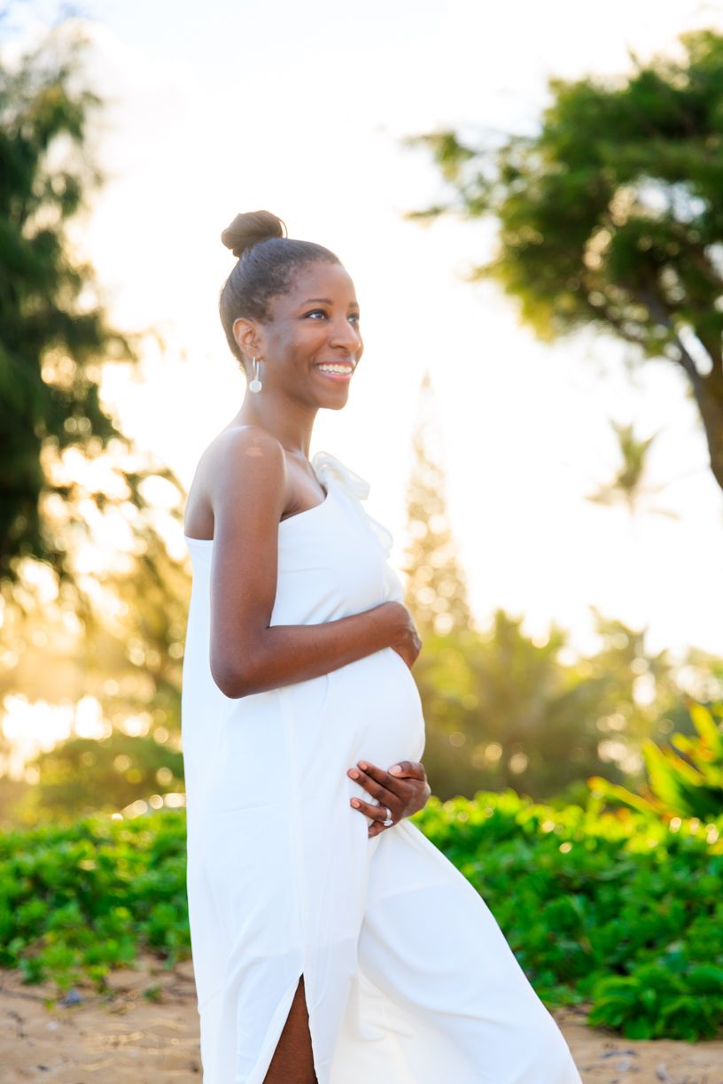 Joyful outdoor maternity portraits with white fabric flowing in the sunset light.