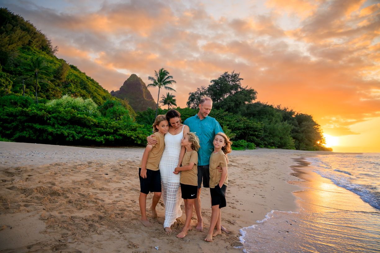 Beautiful beach photography session during a vibrant orange sunset in Hawaii.