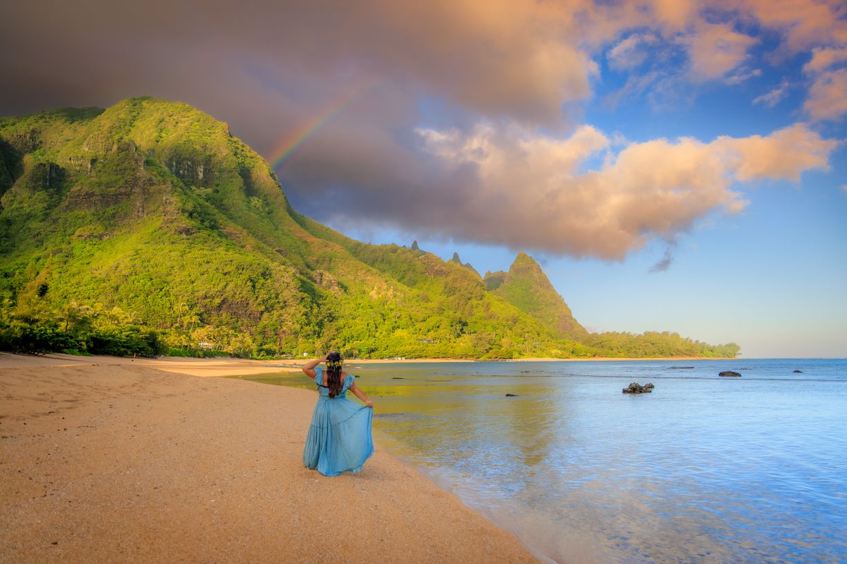 Scenic Hawaiian coastline with dramatic mountains and blue ocean waters.
