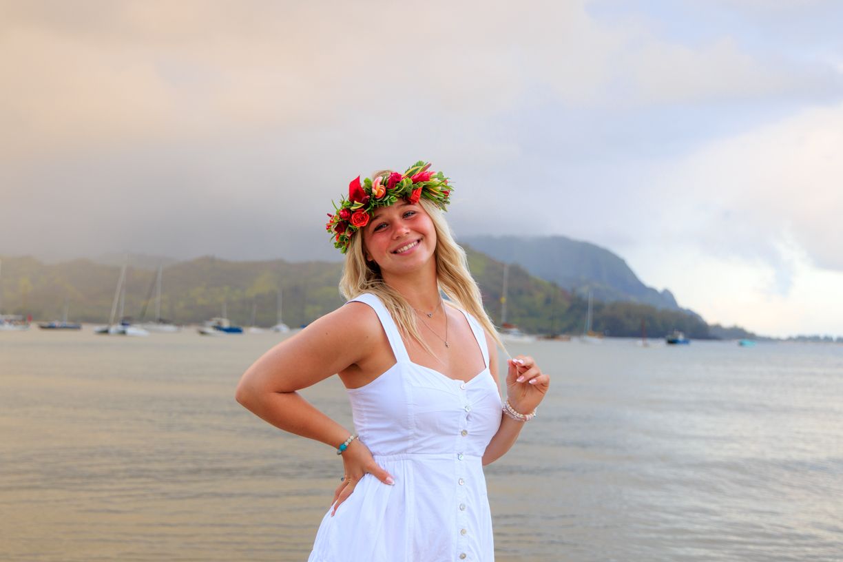 Beachside portrait session with tropical mountain backdrop and ocean views.
