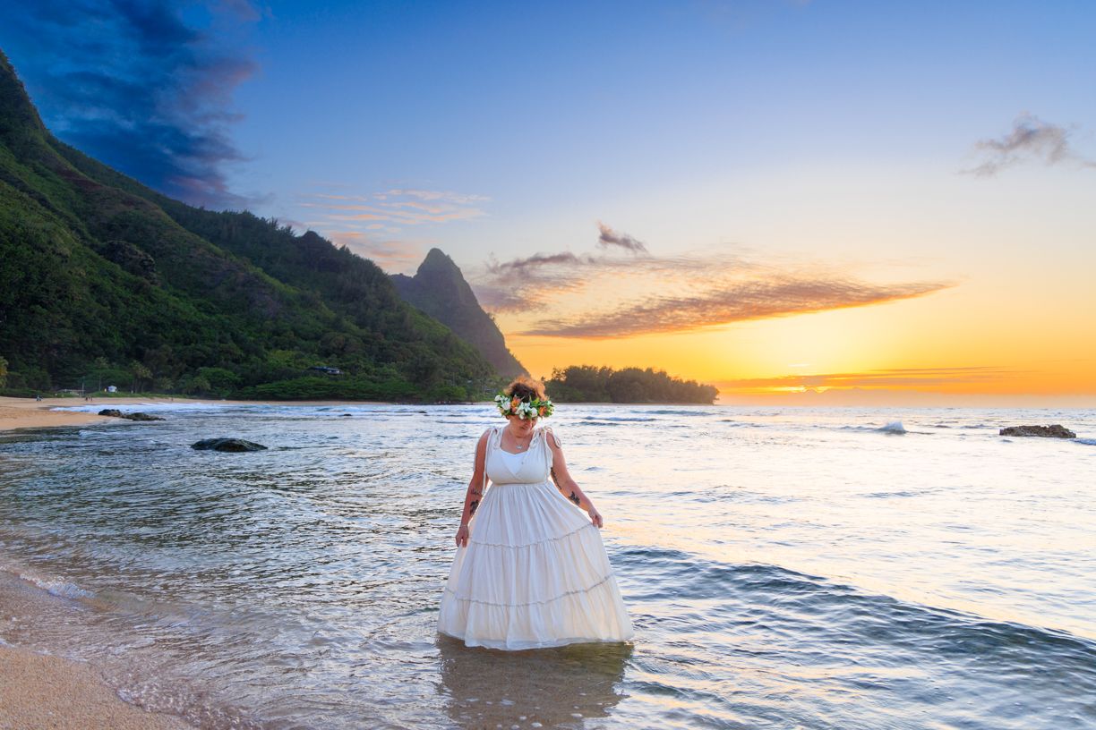 Golden hour beach photography with dramatic mountain landscape and ocean waves.